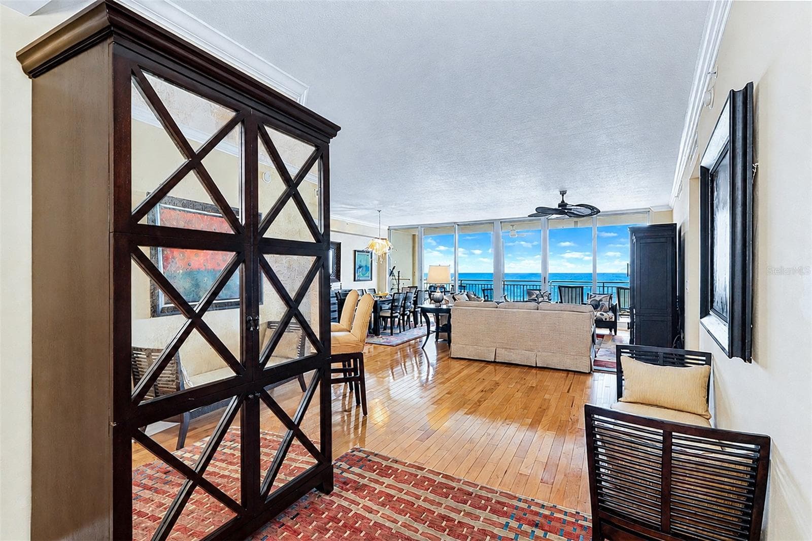 ... Entrance to Residence 404... Inviting Wood Floors, High Ceilings and a Wall of Waterfront Floor To Ceiling Impact Sliders That Seem to Allow the Long Range Aqua Blue Water Views to Drench the Great Room  Grab Your Attention. - 15208 GULF BLVD #404, MADEIRA BEACH
