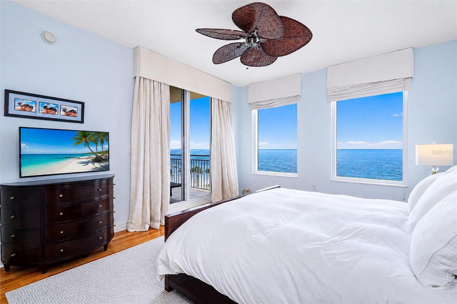 ... Primary / Master Bedroom Suite Looking out towards Gulf.. Wake up in Paradise.. Wood Floors - Custom Black out Drapes - Newer Fan..Balcony Access Thru Sliders. - 15208 GULF BLVD #404, MADEIRA BEACH