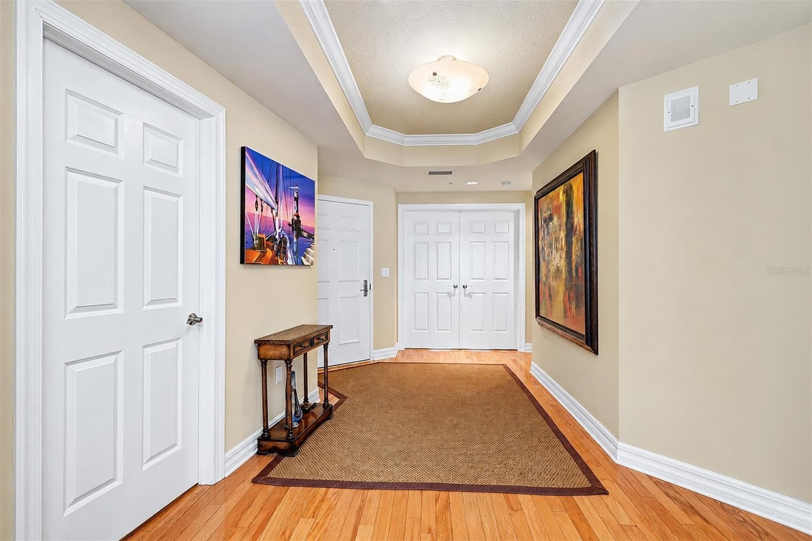 .. Hallway - Looking out From Living Room Area .. Laundry Room to Left - Entrance Door on Far Left.. Main Guest Suite Thru Double Parlor Doors.. NOTE: All Interior Doors are Solid Core.. - 15208 GULF BLVD #404, MADEIRA BEACH