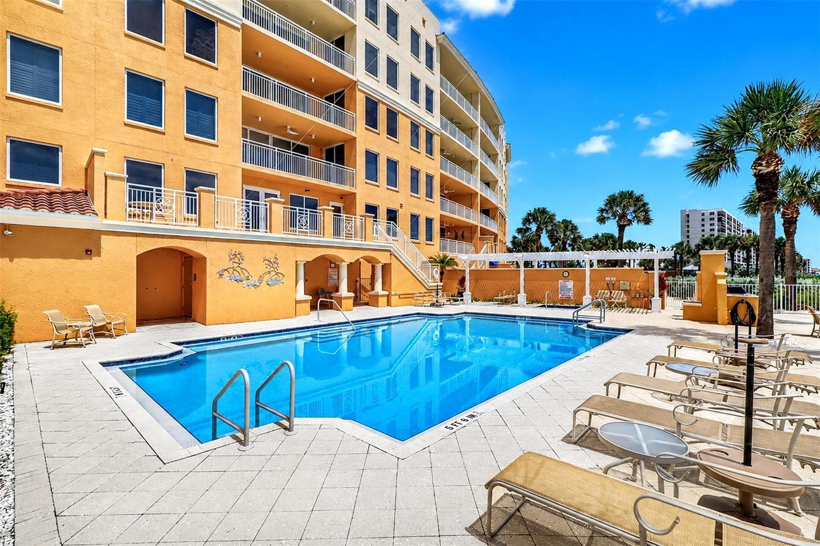 ...   Numerous Lounging Areas at the Sereno.. Stairs with White Railings Lead up to 2nd Floor Landing with  Clubhouse & Gym Facility. - 15208 GULF BLVD #404, MADEIRA BEACH