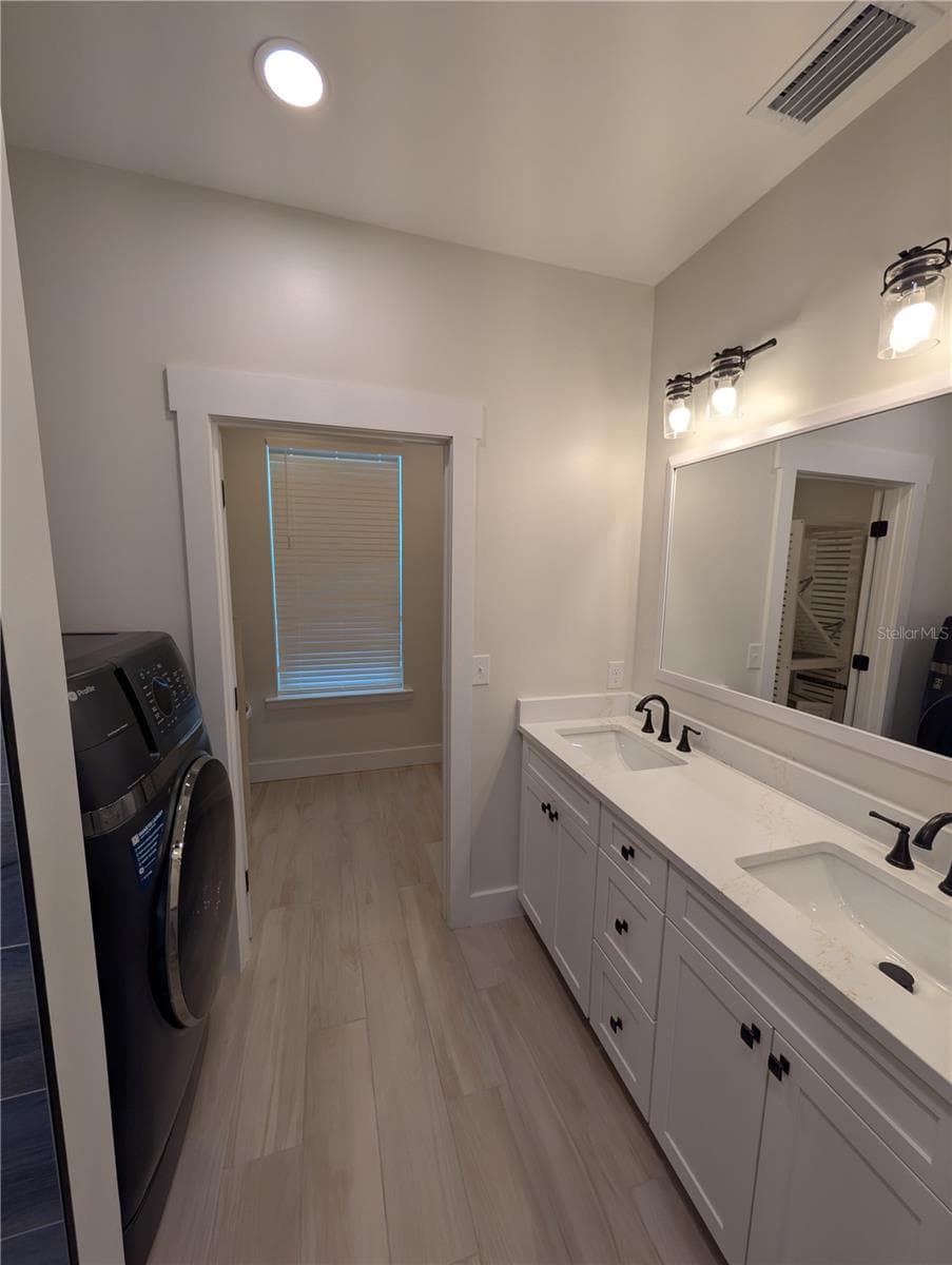 Main House...2nd floor primary bathroom with washing machine/dryer - 414 JESSAMINE BLVD, DAYTONA BEACH