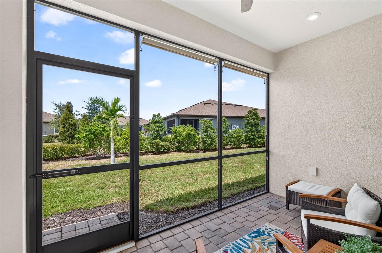 Screened lanai with landscaped view and roll down shades - 864 SNAIL KITE PL, SUN CITY CENTER