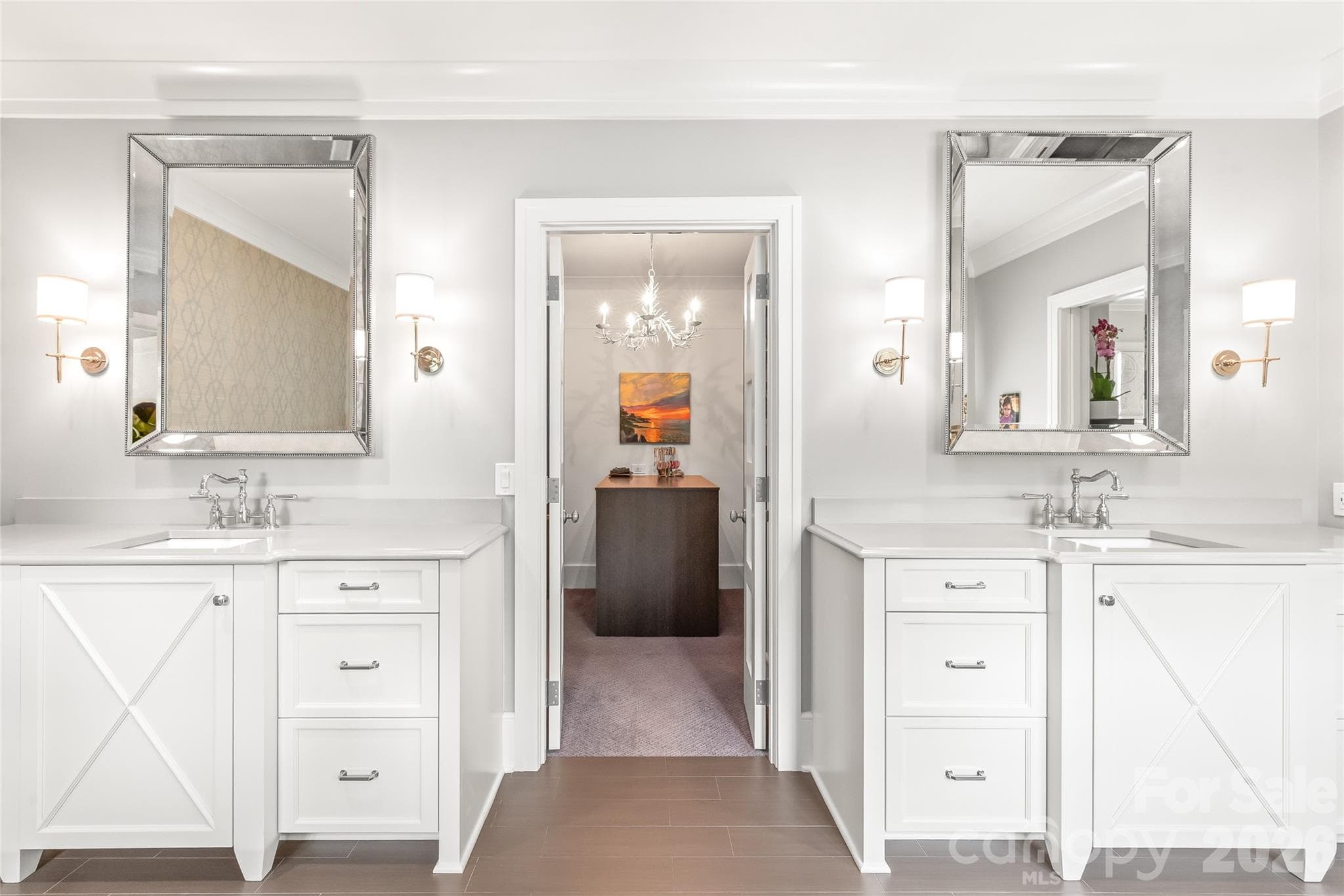 Dual vanities flank the entrance to the primary closet - 2800 Wintergreen Drive, Charlotte