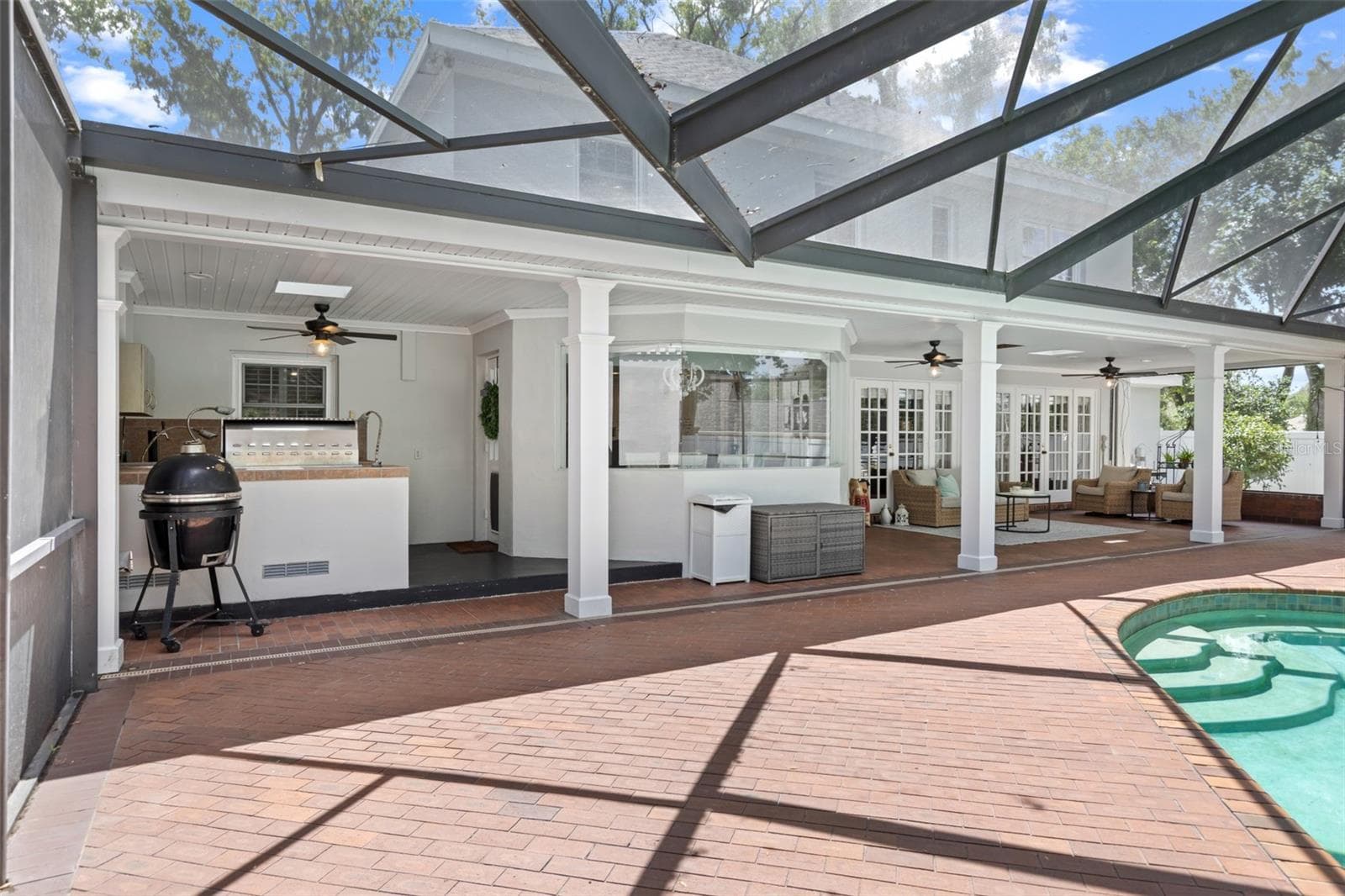 The enormous screened-in lanai with a large covered area is perfect for large gatherings. - 4603 DOGWOOD HILLS CT, BRANDON