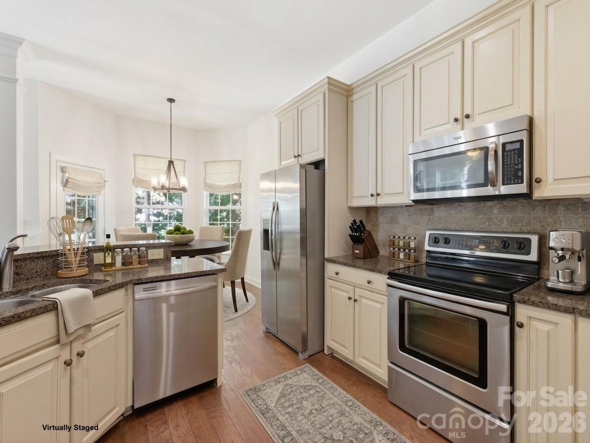 Stainless steel appliances, rich granite countertops, a tumbled marble backsplash! - 6832 Charter Hills Road, Charlotte