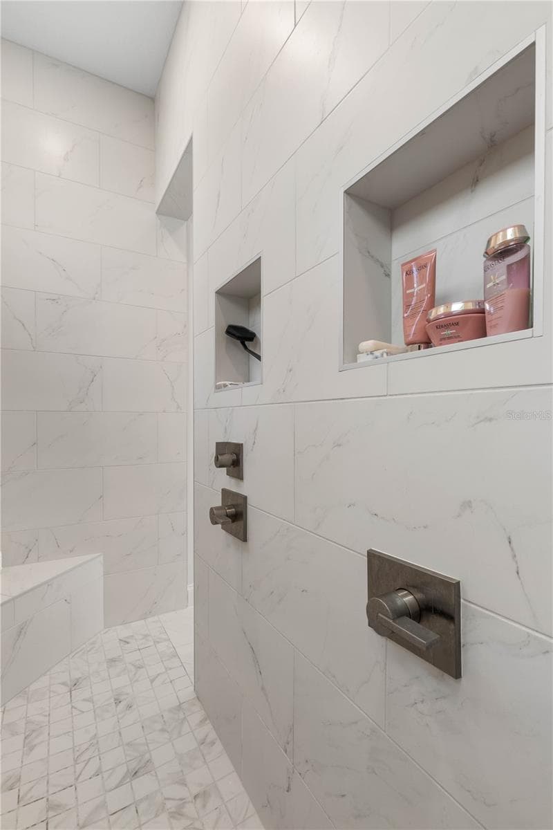 Convenient built-in storage shelves in the walk-through shower - 23 OCEAN RIDGE BLVD N, PALM COAST