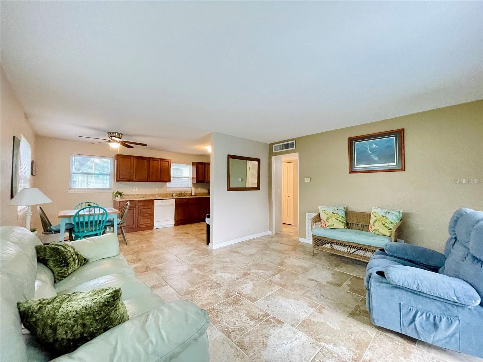Spacious living area with an open connection to the kitchen and dining space, creating an easy flow for everyday living and entertaining. - 723 STEELE AVE, SOUTH DAYTONA
