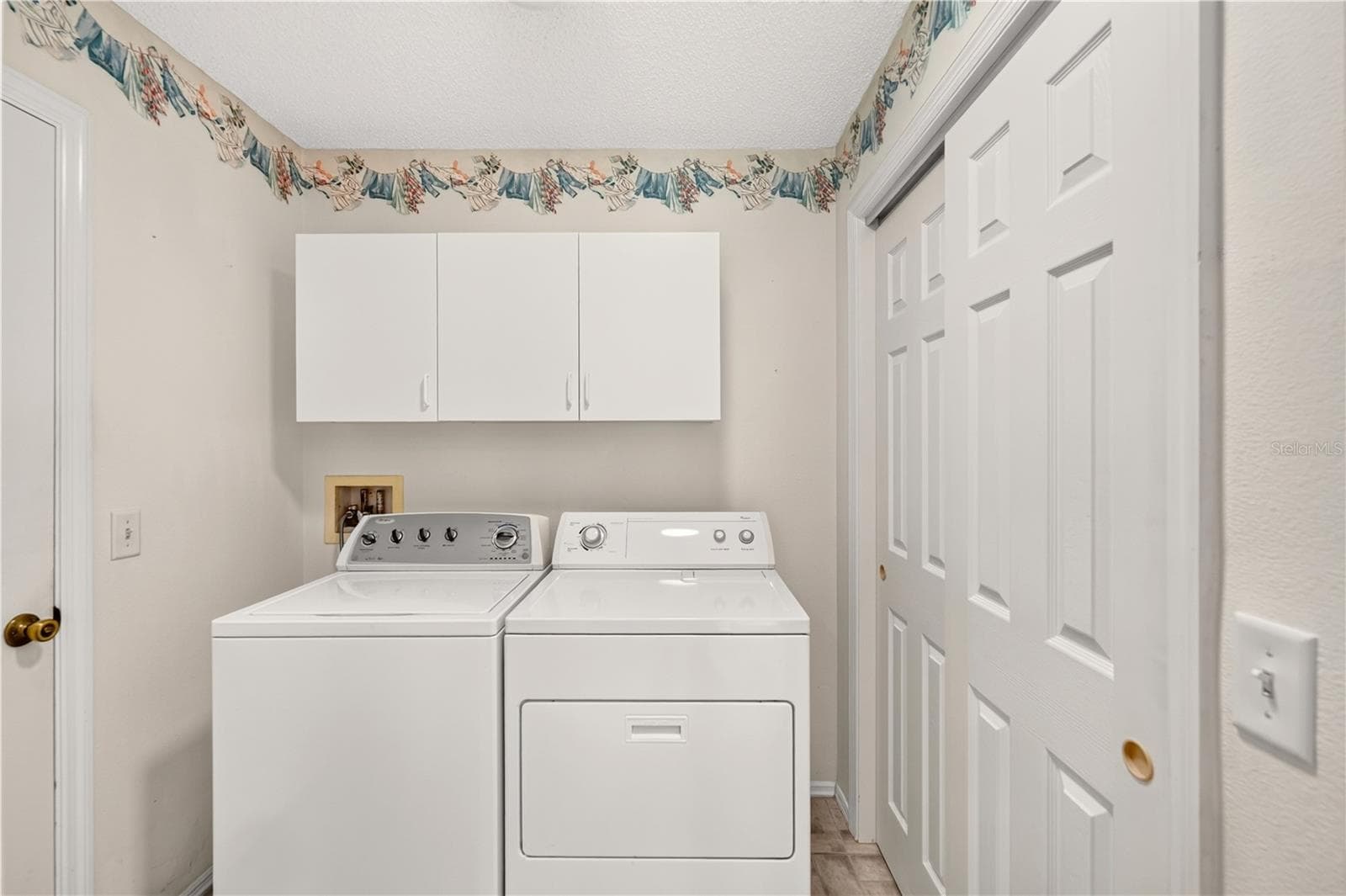 The indoor laundry has tons of storage, including a closet. - 8214 SE 169TH PALOWNIA LOOP, THE VILLAGES
