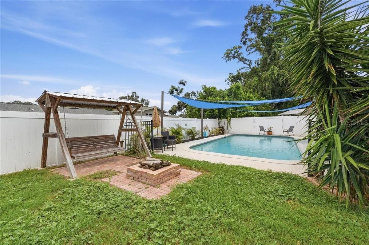 Back yard with firepit and pool - 121 LOWELL RD, WINTER HAVEN