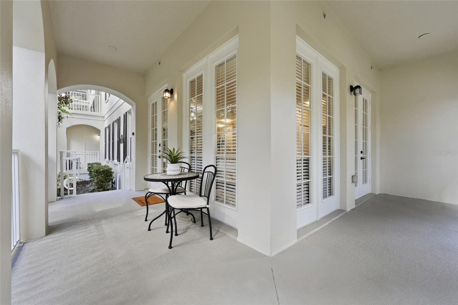 Expansive covered outdoor living space wraps around this desirable ground-floor corner residence. - 1674 LAKEMONT AVE #101, ORLANDO