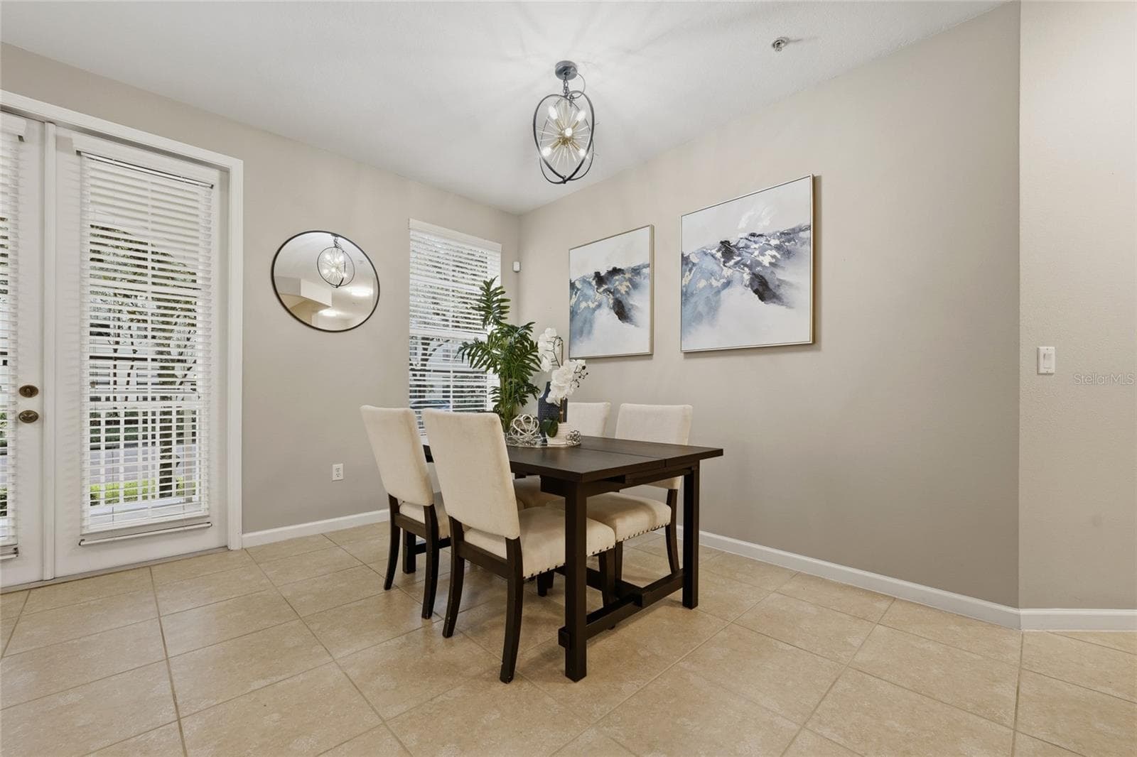 Dedicated dining area with abundant natural light and direct access to the covered outdoor space. - 1674 LAKEMONT AVE #101, ORLANDO