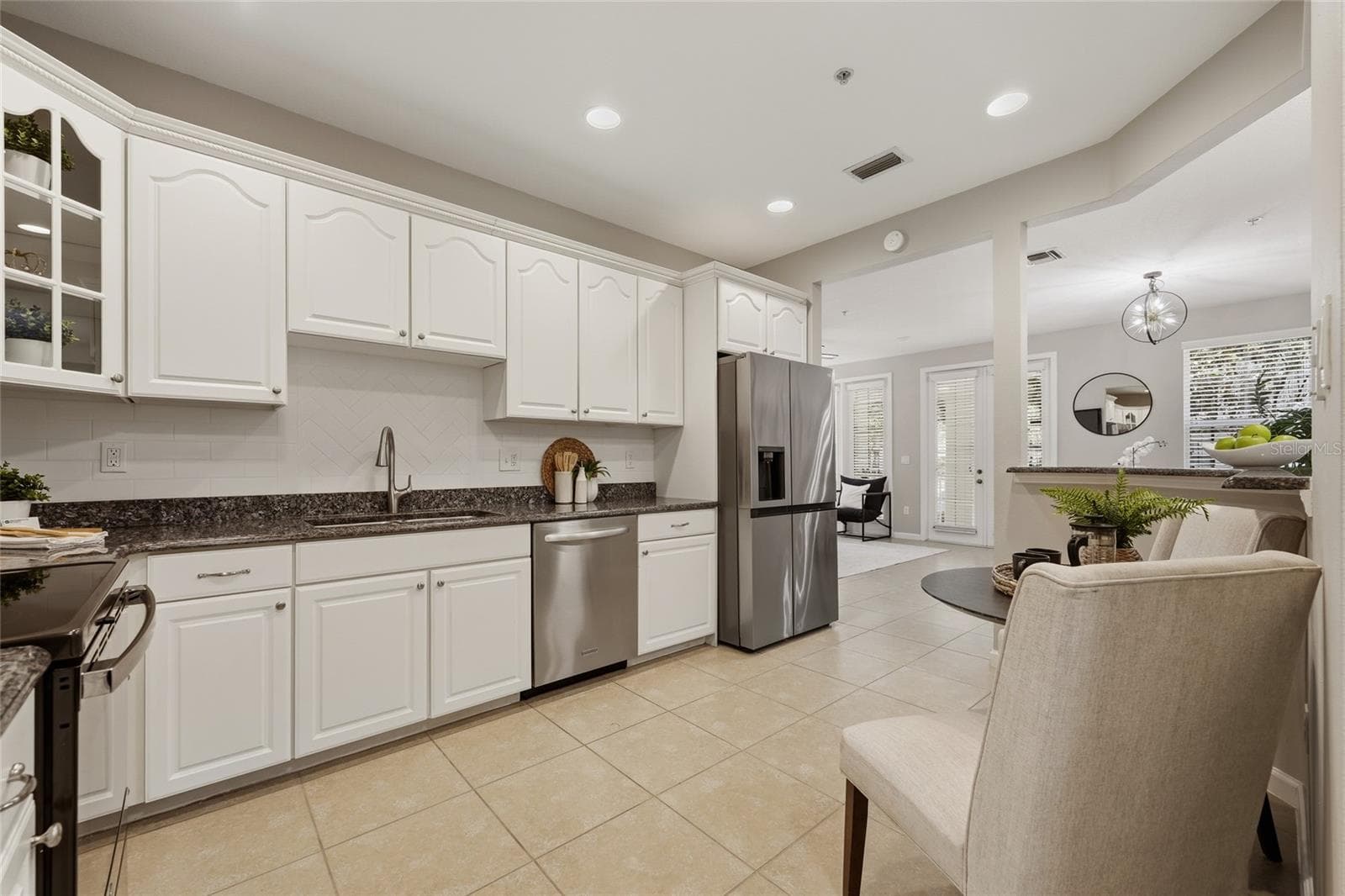 Kitchen flows seamlessly into the living space, highlighting the open layout and easy connection between rooms. - 1674 LAKEMONT AVE #101, ORLANDO