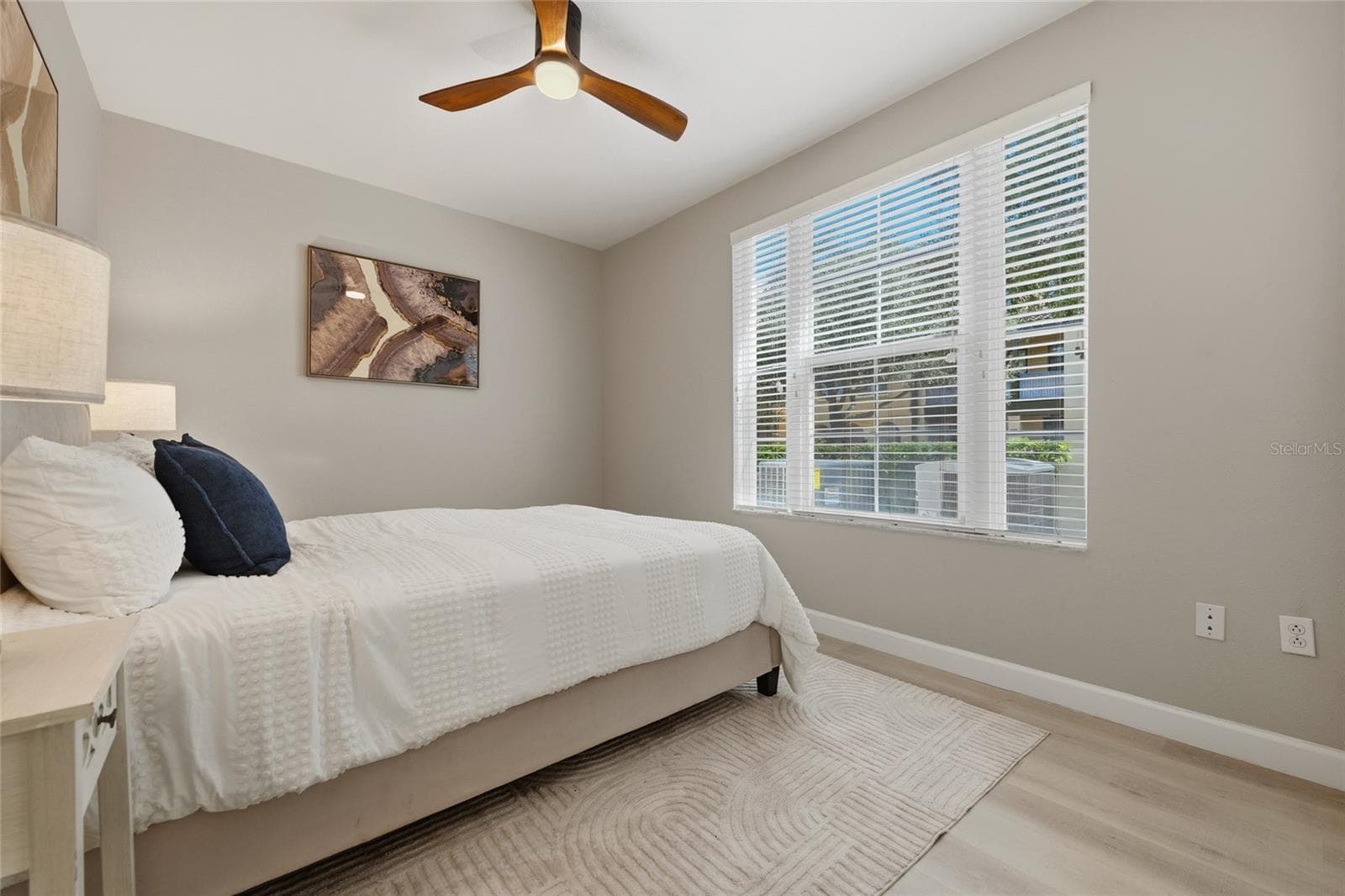 Bright secondary bedroom with updated flooring, ceiling fan and generous natural light. - 1674 LAKEMONT AVE #101, ORLANDO