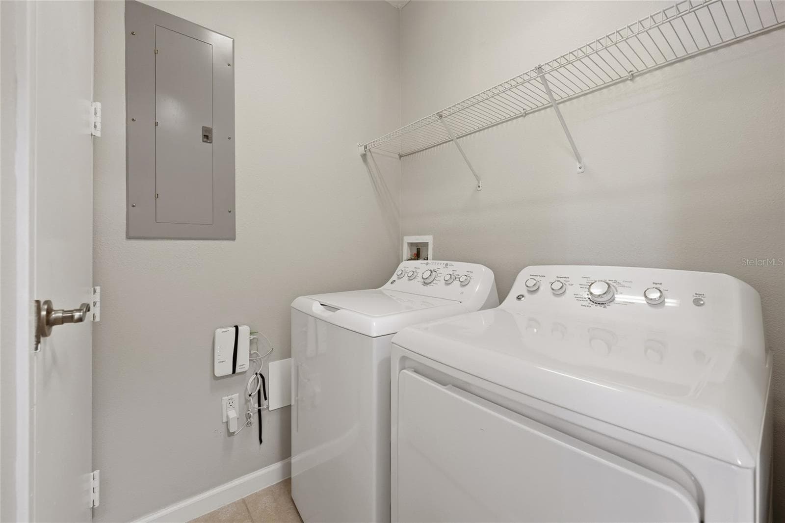 Convenient in-unit laundry room with full-size washer and dryer plus additional shelving. - 1674 LAKEMONT AVE #101, ORLANDO