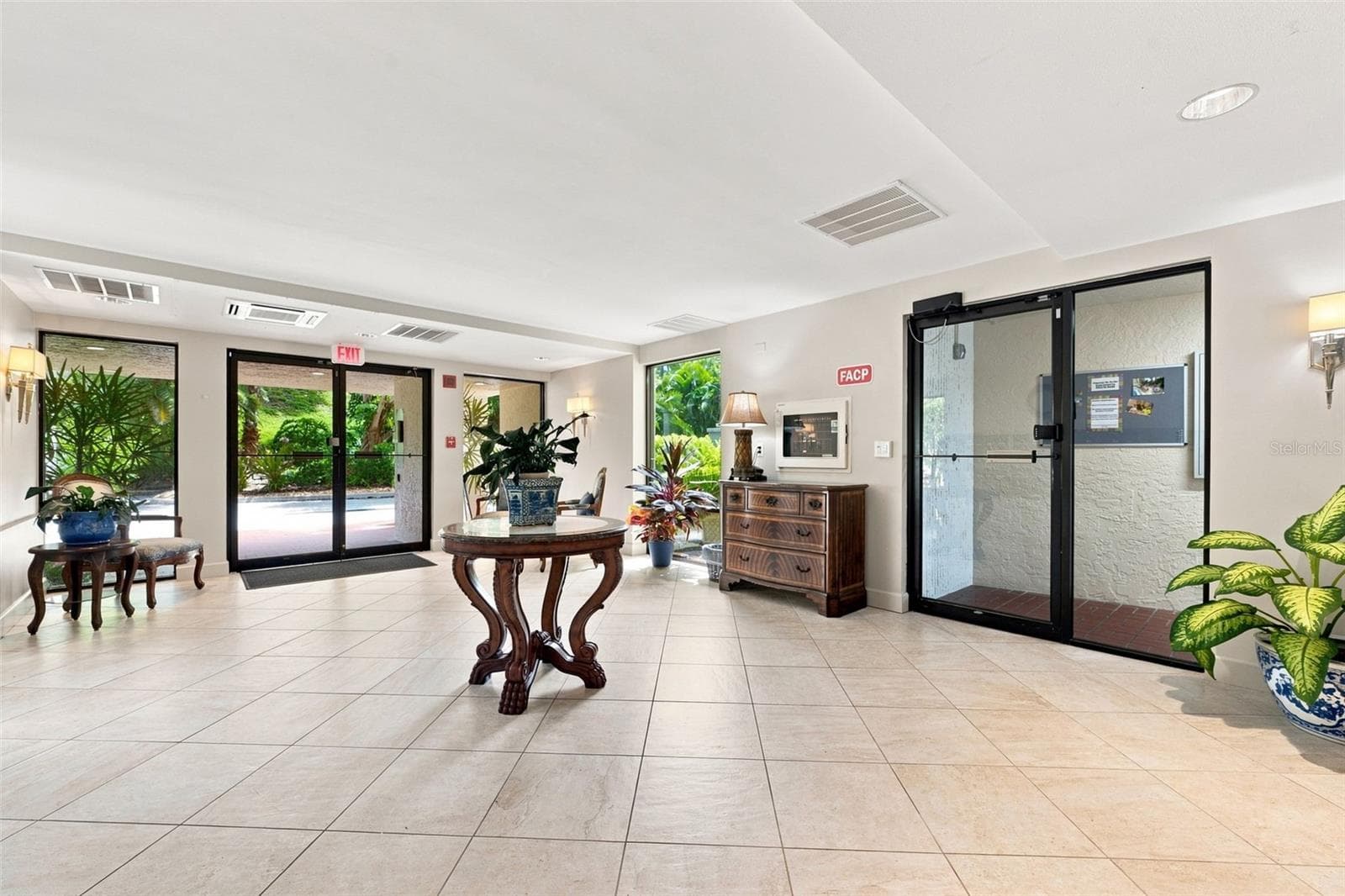 Lobby entrance from under building garage and front open parking - 55 ROGERS ST #204, CLEARWATER