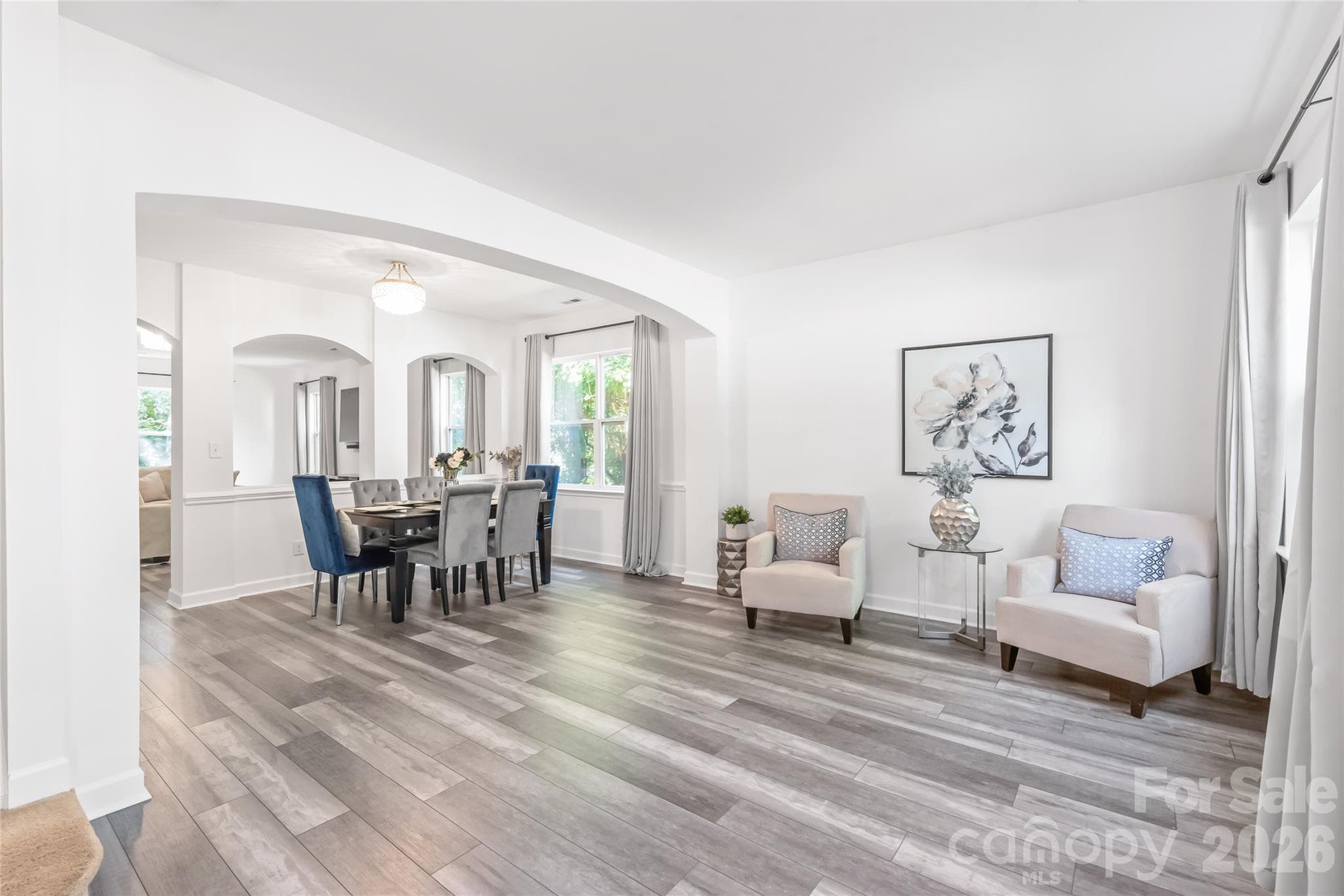 "Experience the beautiful, spacious, and inviting atmosphere of our open-plan living and dining room area." - 6404 Lanzerac Manor Drive, Charlotte