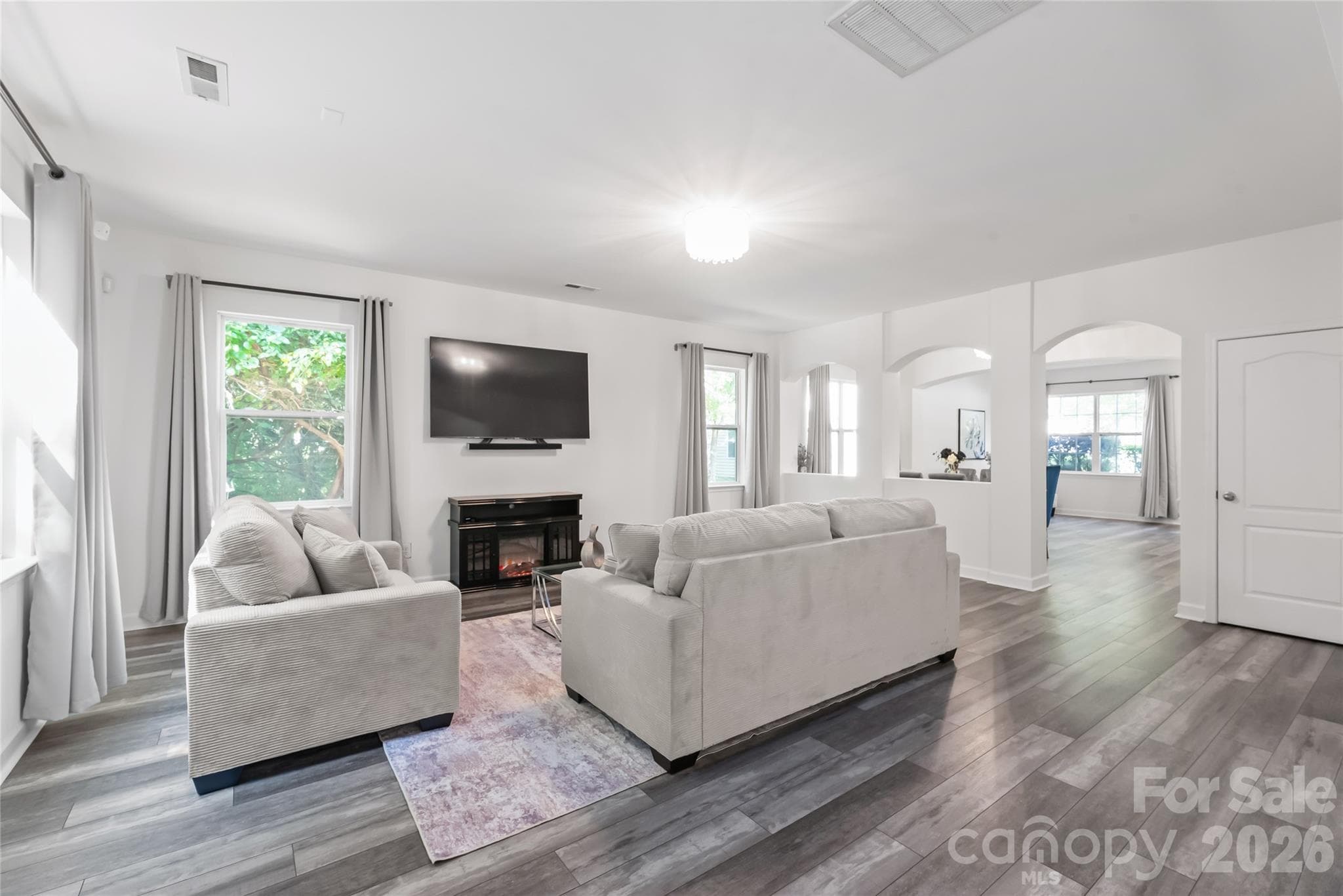 "The great room featuring beautiful LVP flooring on the lower level." - 6404 Lanzerac Manor Drive, Charlotte