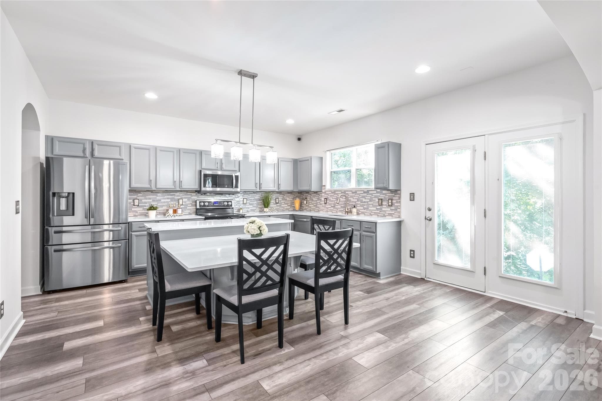 "Experience the joy of cooking in a kitchen designed around a generous island, perfect for both meal preparation and gathering with loved ones." - 6404 Lanzerac Manor Drive, Charlotte