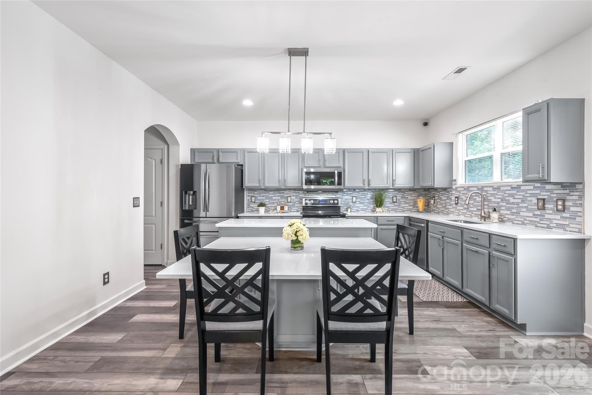 "The spacious kitchen includes a built-in dining area, making it ideal for hosting enjoyable gatherings." - 6404 Lanzerac Manor Drive, Charlotte