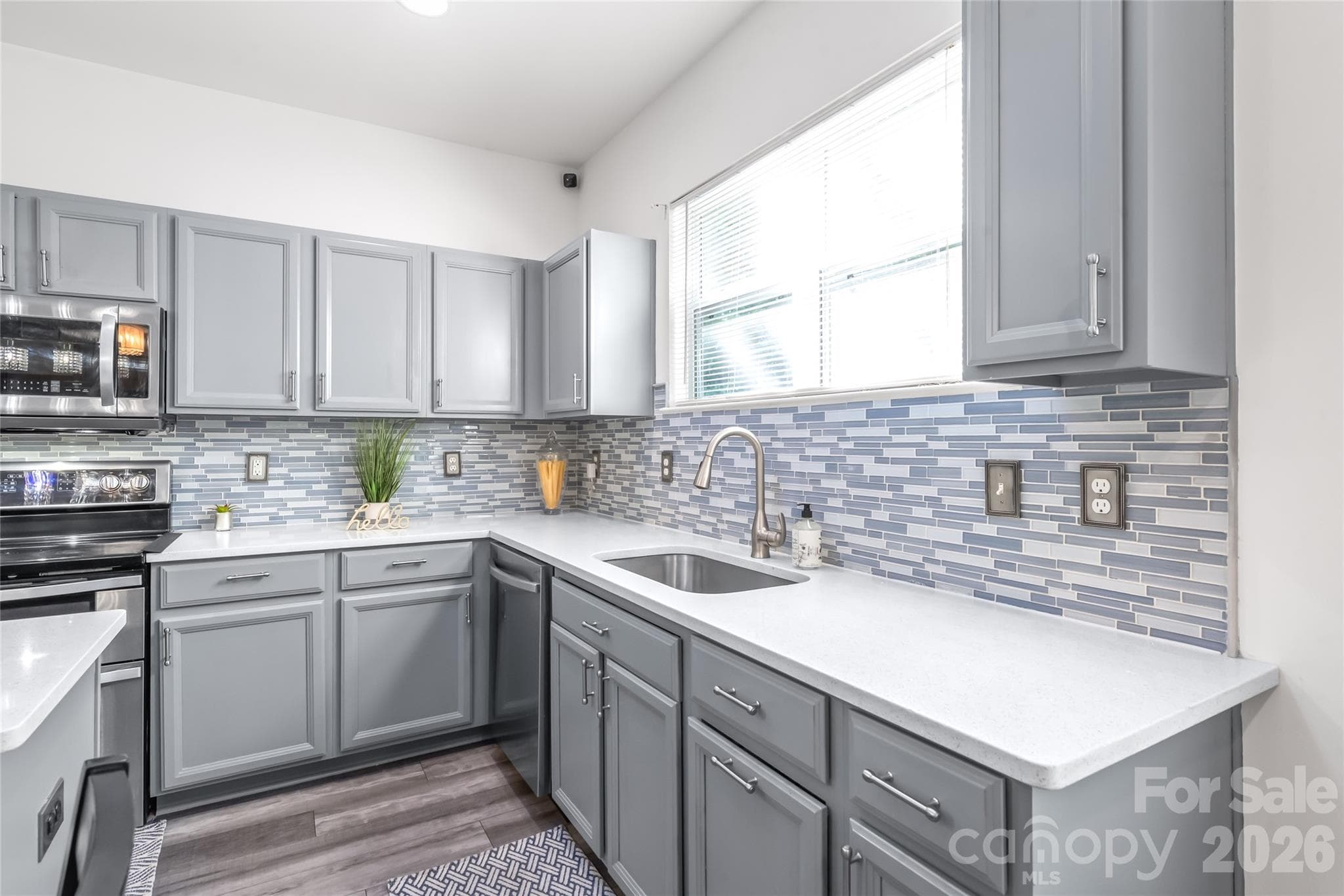 "A Lovely kitchen with a beautifully designed backsplash." - 6404 Lanzerac Manor Drive, Charlotte