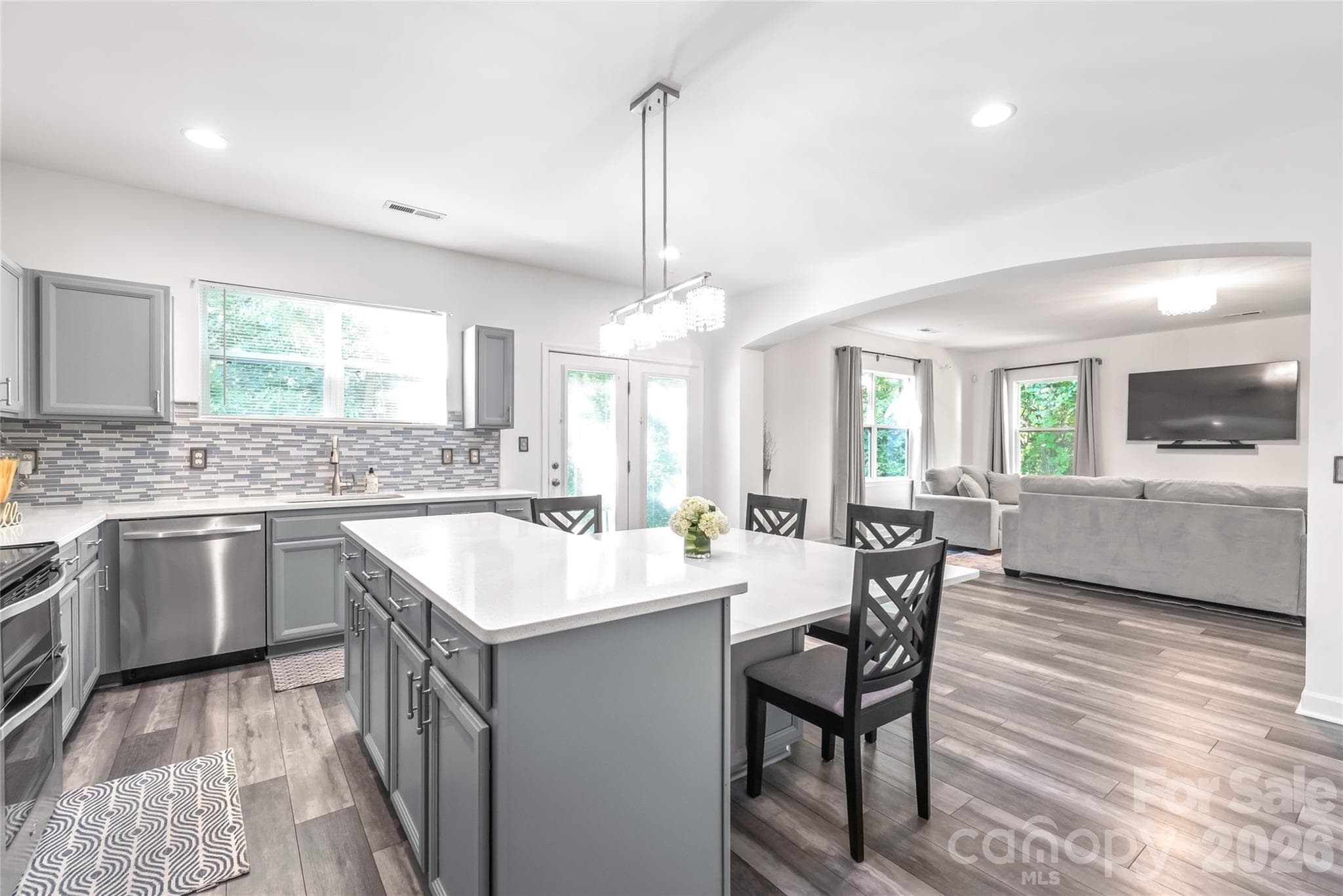 "Open concept kitchen and great room featuring a spacious, light filled layout perfect for entertaining." - 6404 Lanzerac Manor Drive, Charlotte