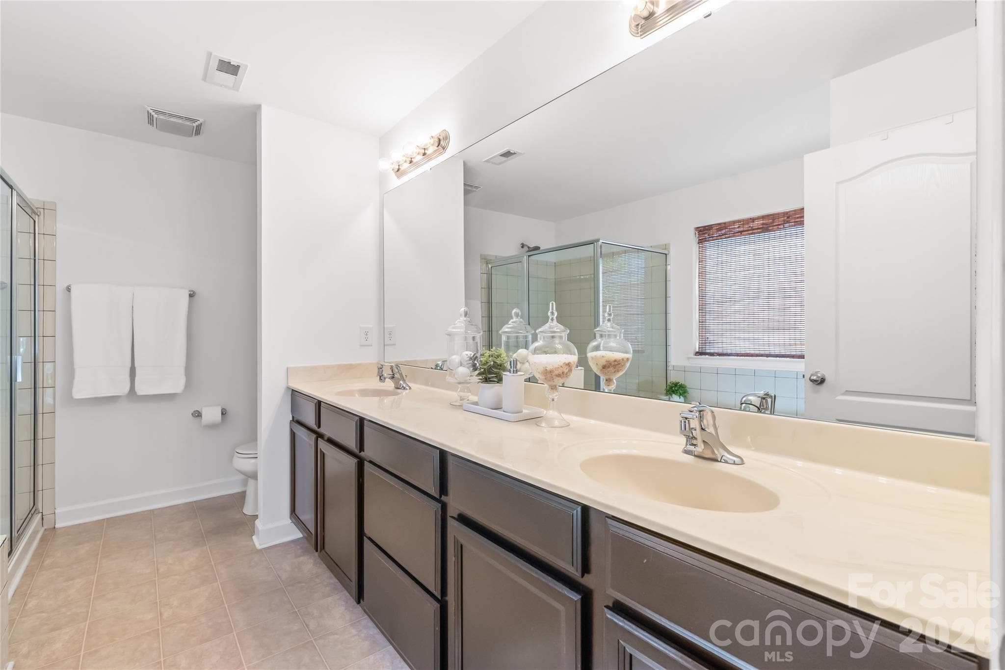 "Main suite bathroom equipped with a double vanity and ample counter space." - 6404 Lanzerac Manor Drive, Charlotte