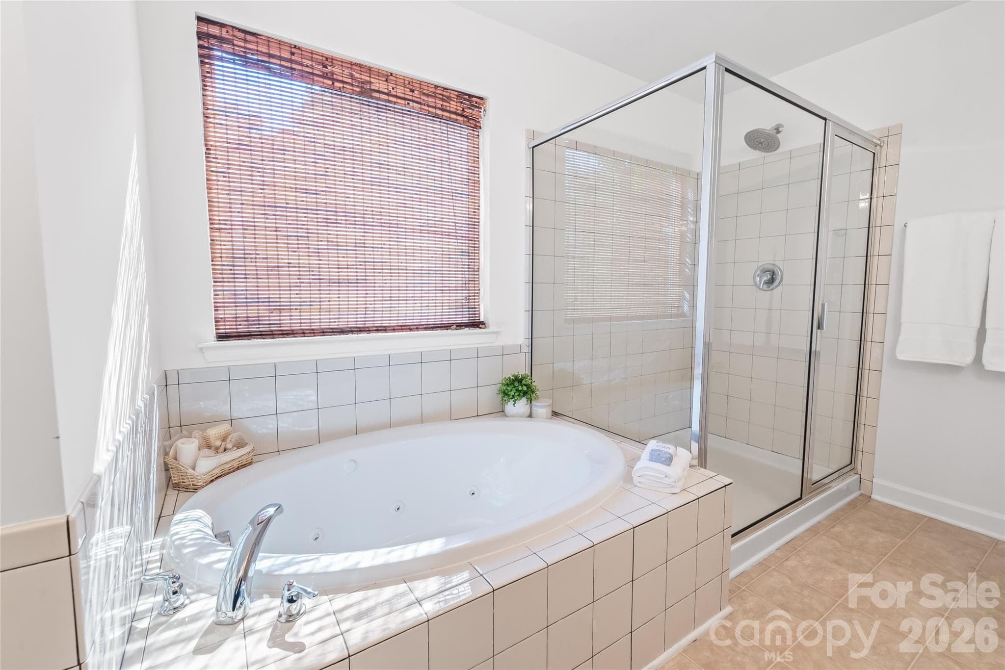 "Luxurious deep soaking tub in the primary bathroom, perfect for relaxing." - 6404 Lanzerac Manor Drive, Charlotte