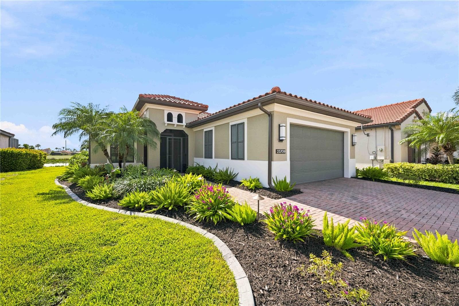 The Landscaping and curbing on this home is superb. - 23709 WAVERLY CIR, VENICE