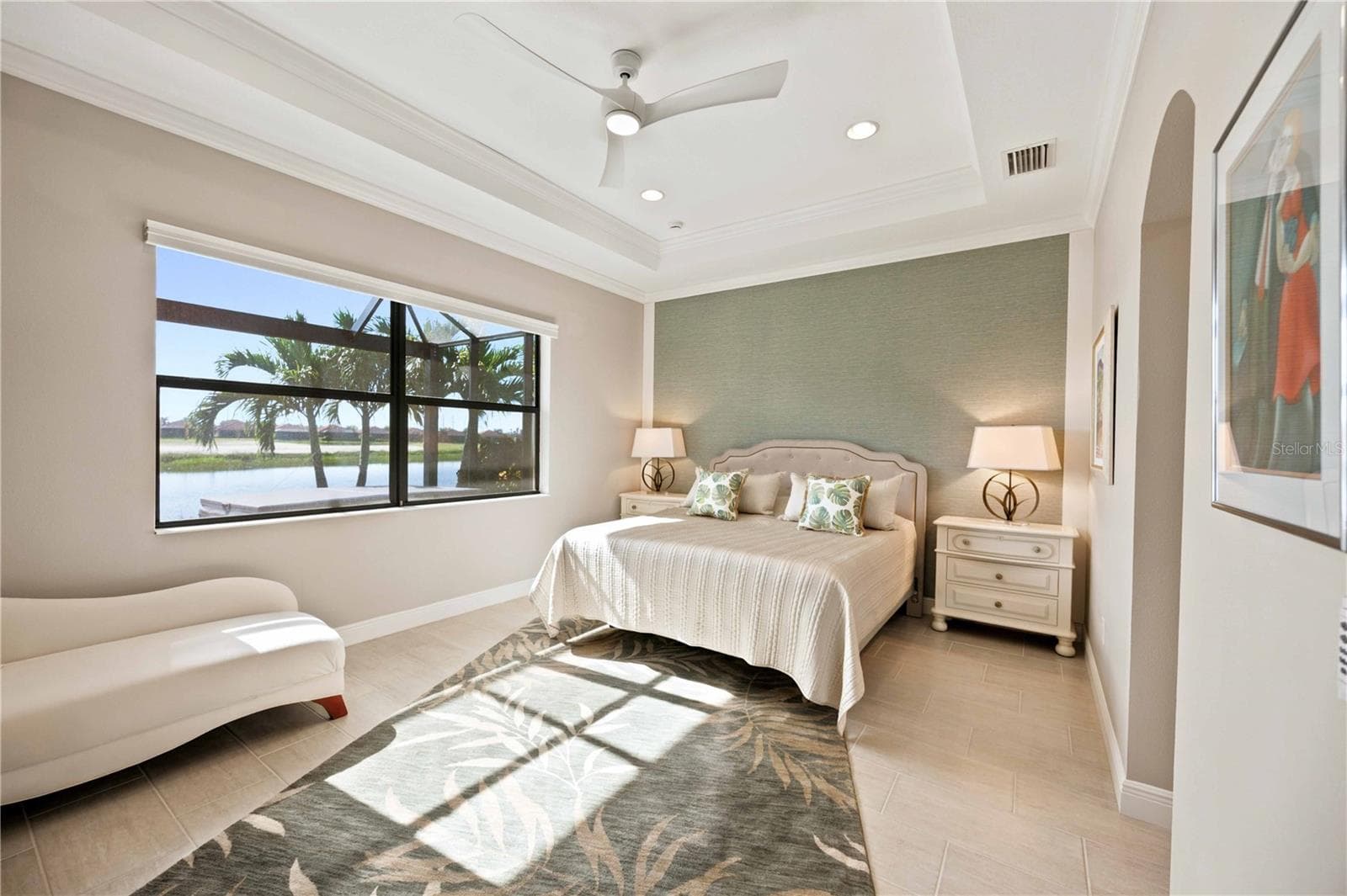 The primary bedroom is large and has lots of light overlooking the water - tile throughout. - 23709 WAVERLY CIR, VENICE