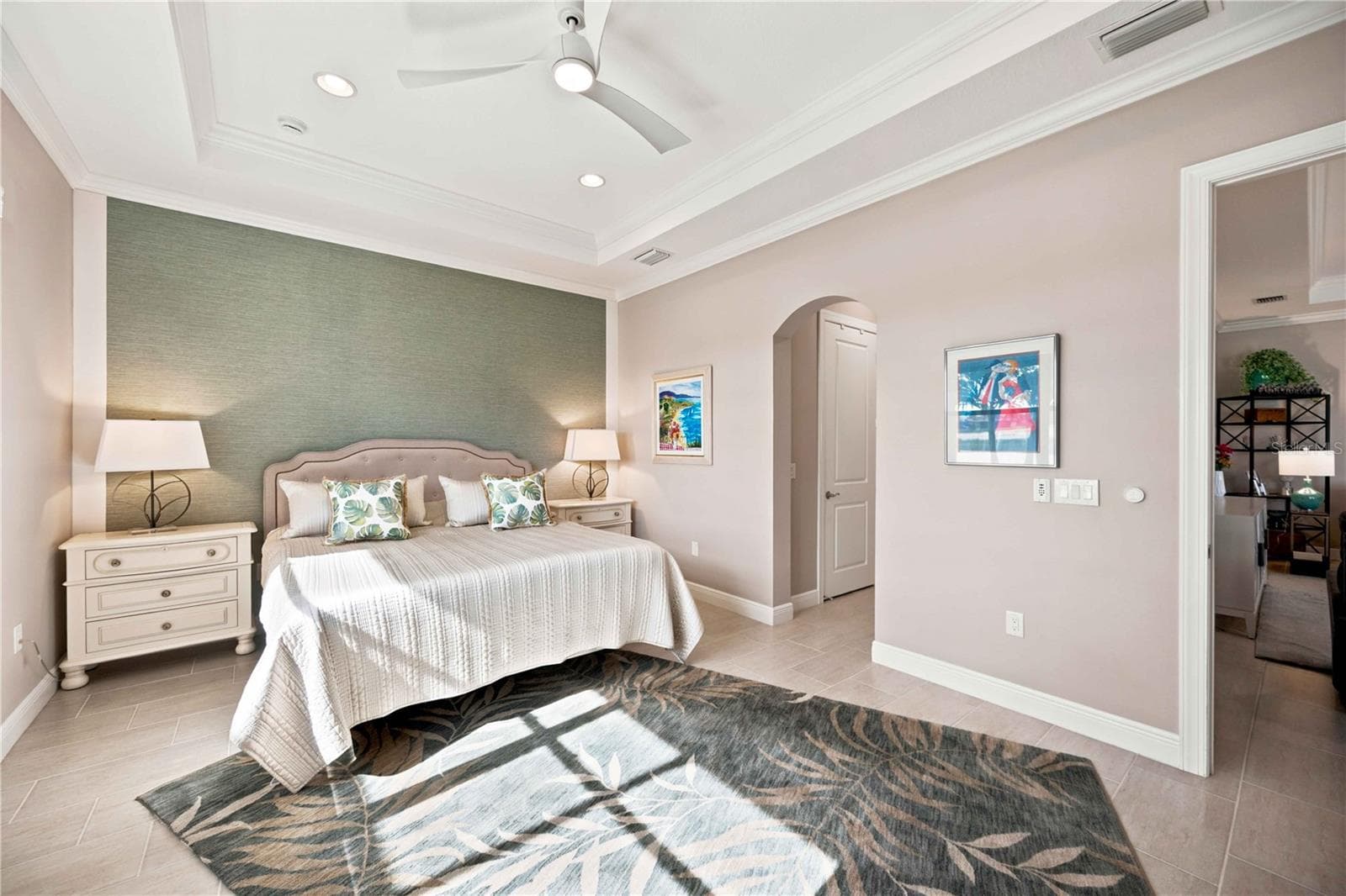 The primary bedroom is large and has lots of light overlooking the water - tile throughout. - 23709 WAVERLY CIR, VENICE