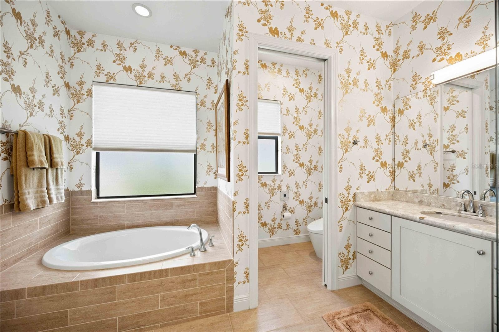 The primary ensuite has dual vanities, a large walk in shower, a soaking tub and private water closet. - 23709 WAVERLY CIR, VENICE