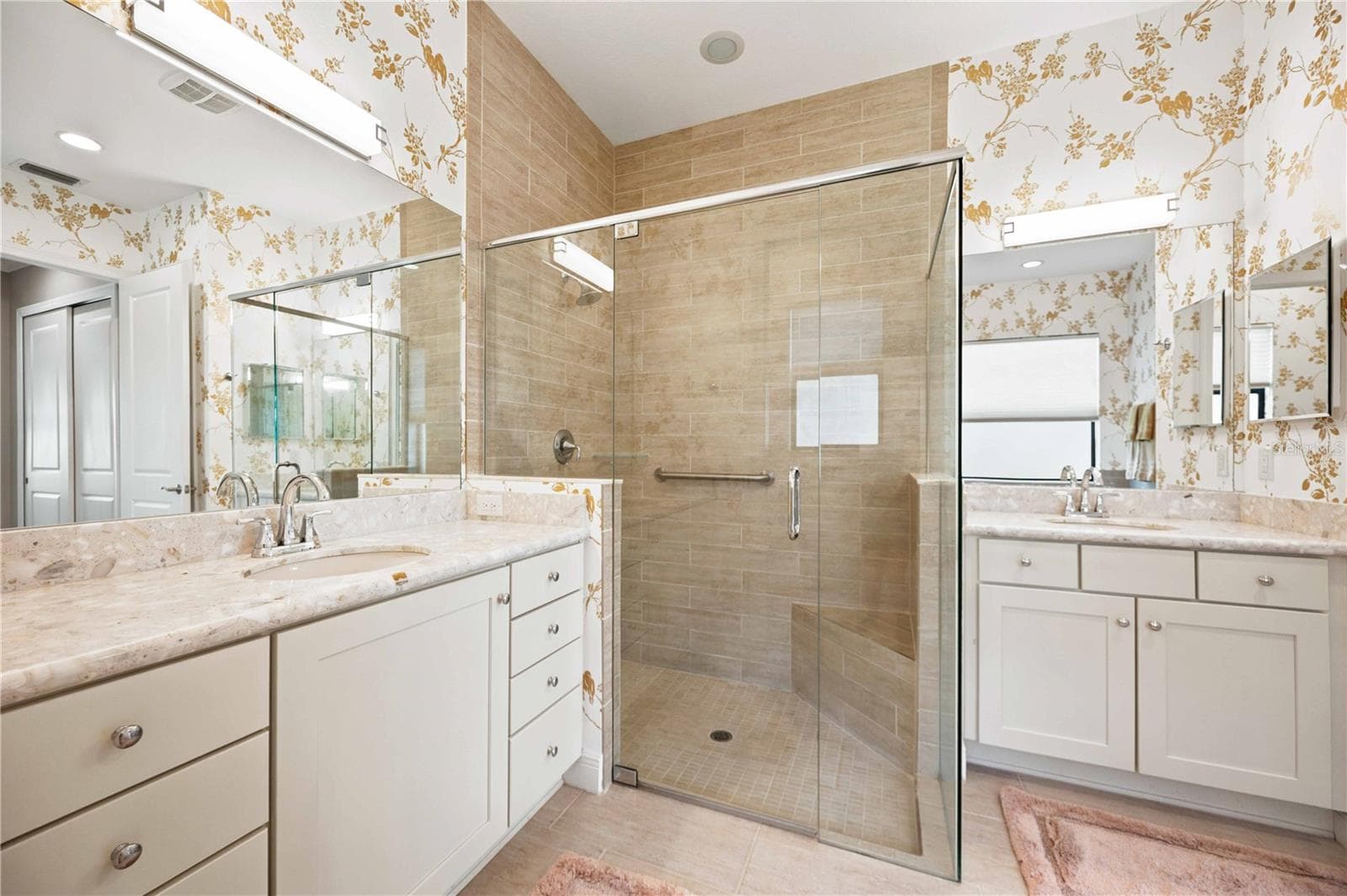 The primary ensuite has dual vanities, a large walk in shower, a soaking tub and private water closet. - 23709 WAVERLY CIR, VENICE