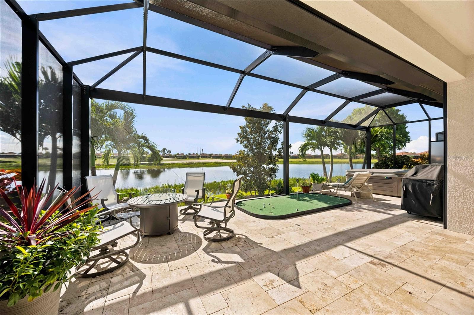 The travertine lanai is stunning.  A fabulous spot to relax. Extensive outdoor cabinets help keep you organized in the outdoor environment - 23709 WAVERLY CIR, VENICE