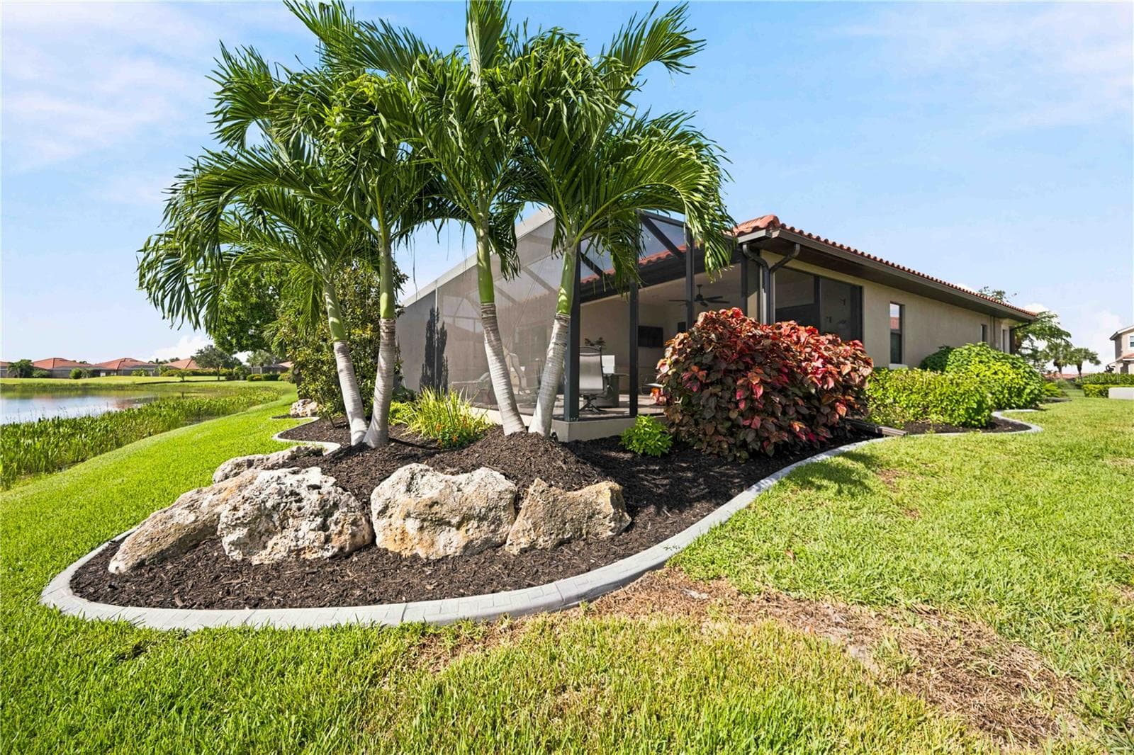 The back yard landscaping is just as beautiful as the front - - 23709 WAVERLY CIR, VENICE