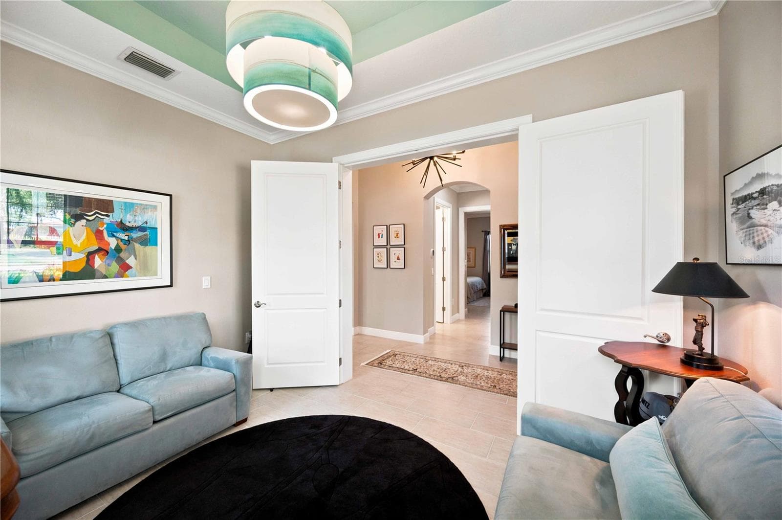 Den showcasing twin french wood doors - light does not convey - 23709 WAVERLY CIR, VENICE