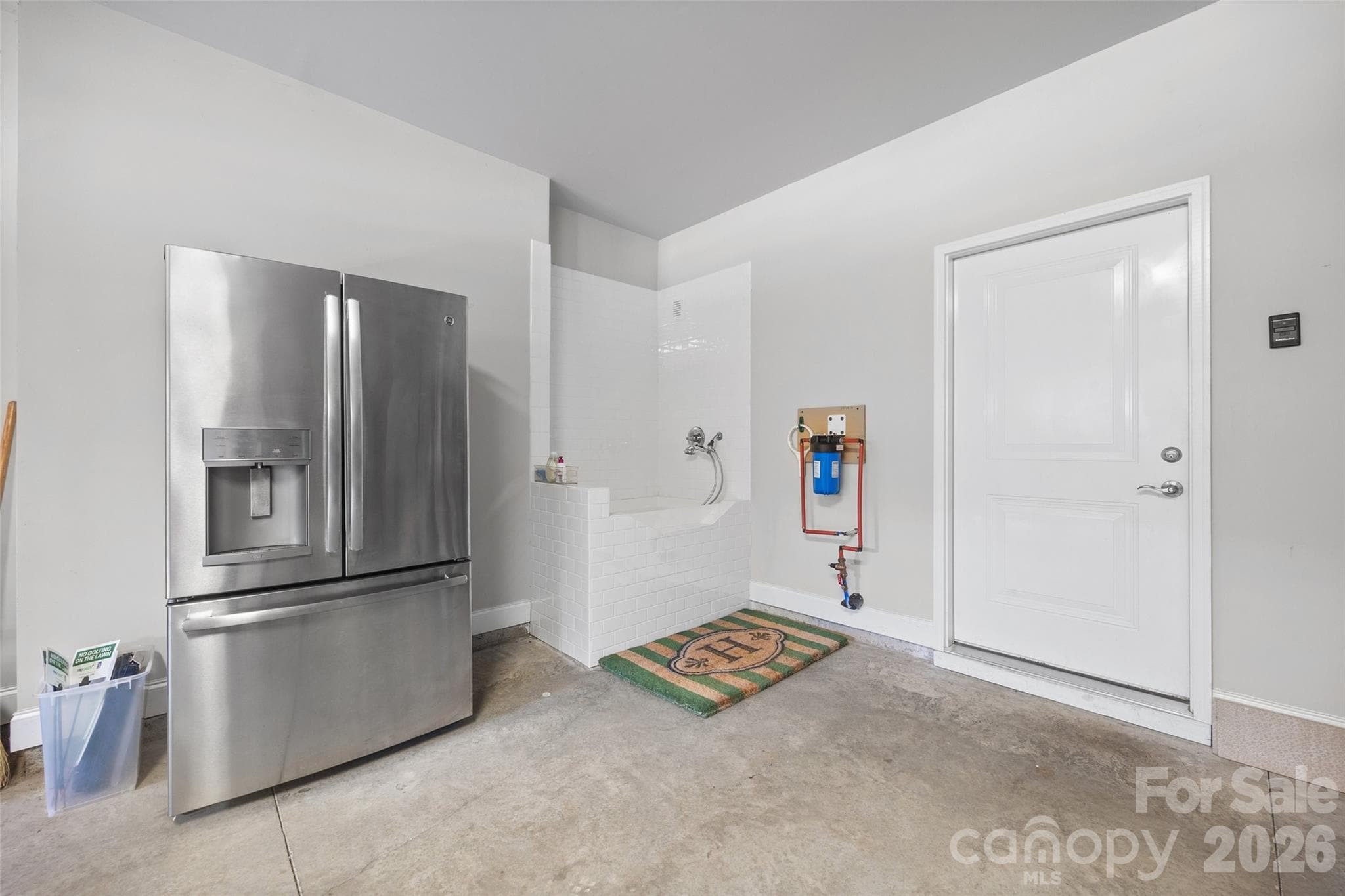 Garage with extra fridge and pet washing station - 420 Trillium Way, Belmont