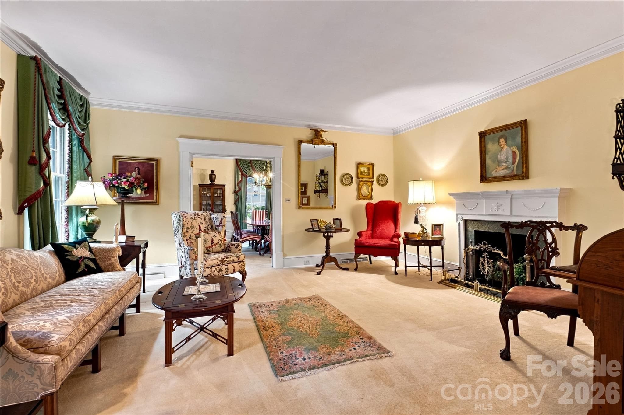 Formal living room with natural light and a decorative fireplace. - 209 Labans Lane, Lincolnton