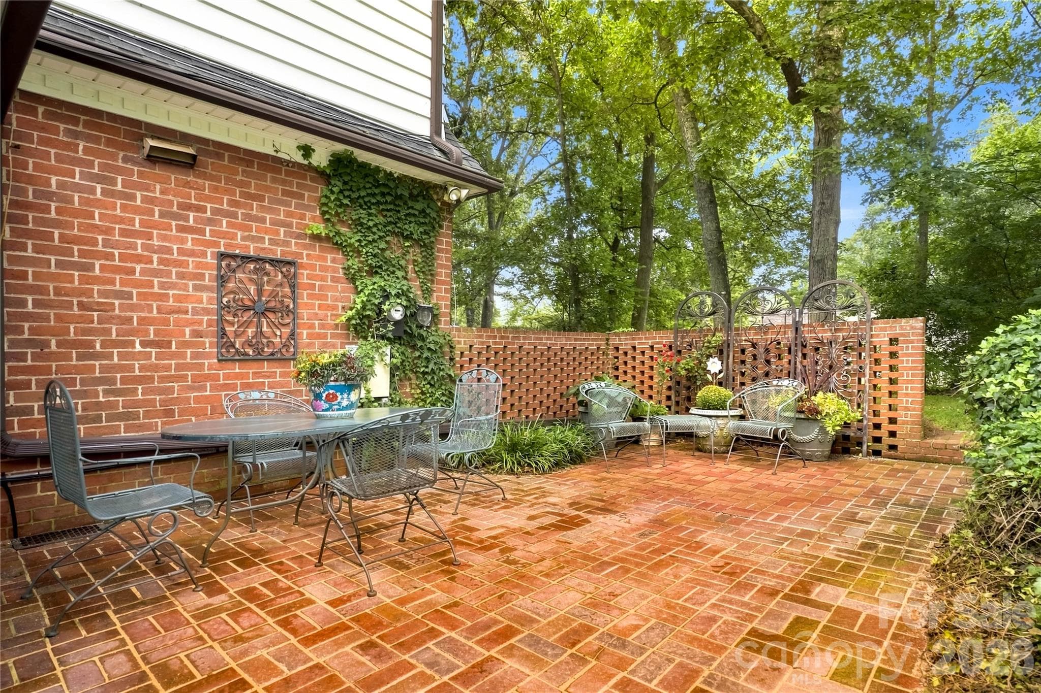 Private brick patio surrounded by established landscaping. - 209 Labans Lane, Lincolnton