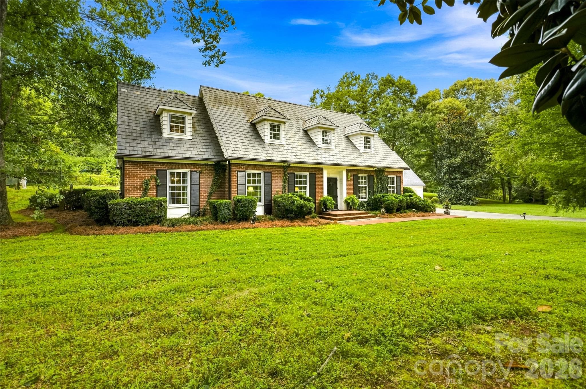 Classic front exterior with slate roof and dormer windows. - 209 Labans Lane, Lincolnton