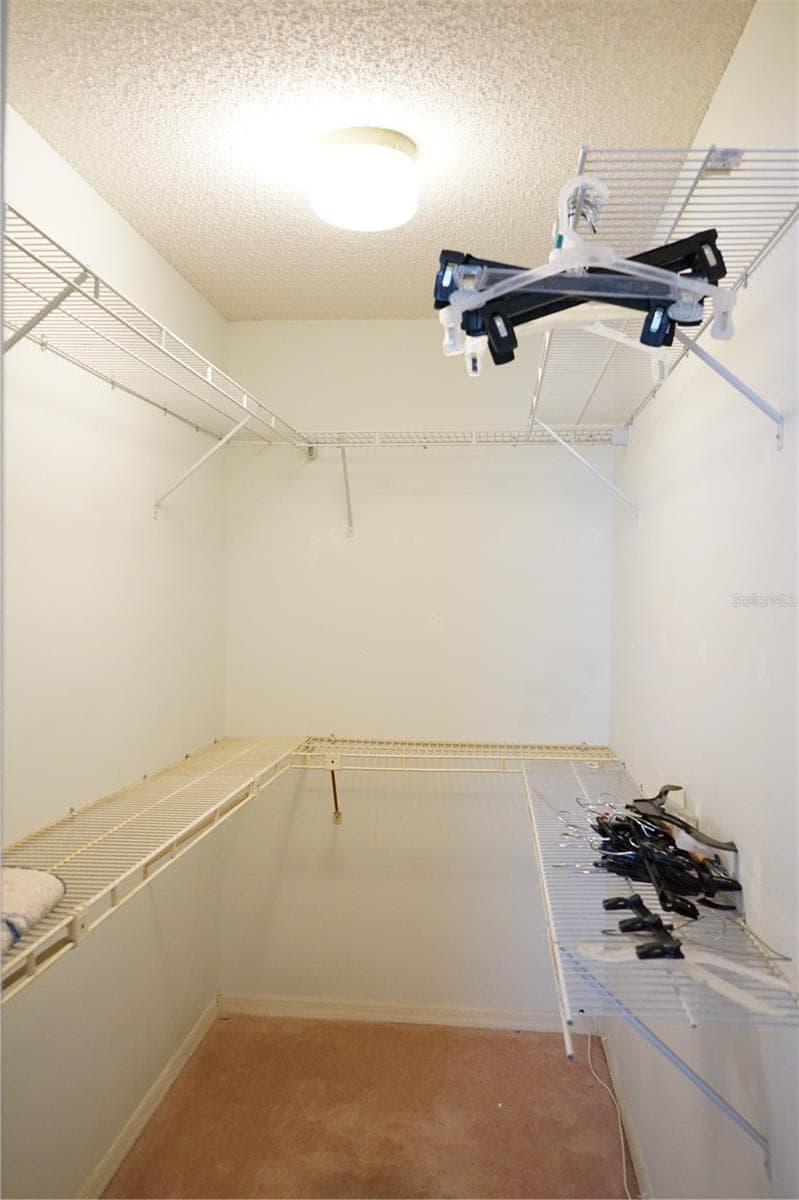 walk in closet - 1904 CANTERBURY LN #24, SUN CITY CENTER