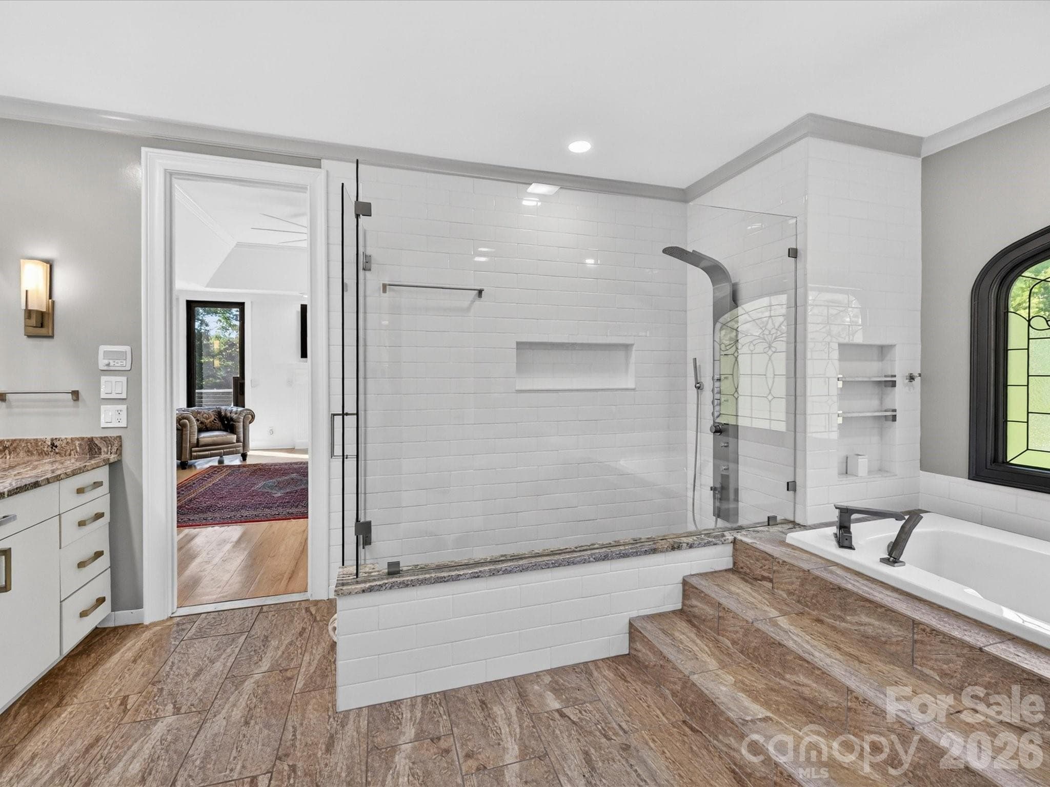Primary bath with walk-in shower, soaking tub, dual vanities, & its own washer and dryer space. - 2723 Providence Pine Lane, Charlotte