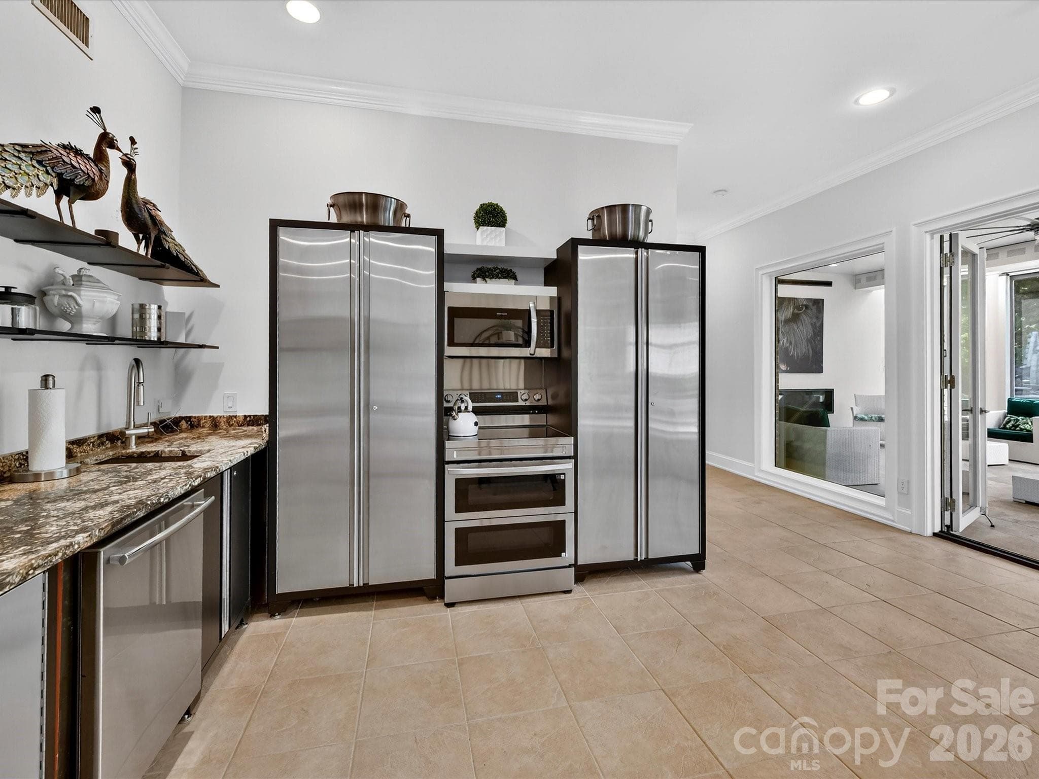 The lower level kitchen makes fun entertaining a breeze in the large family room and outdoors. - 2723 Providence Pine Lane, Charlotte