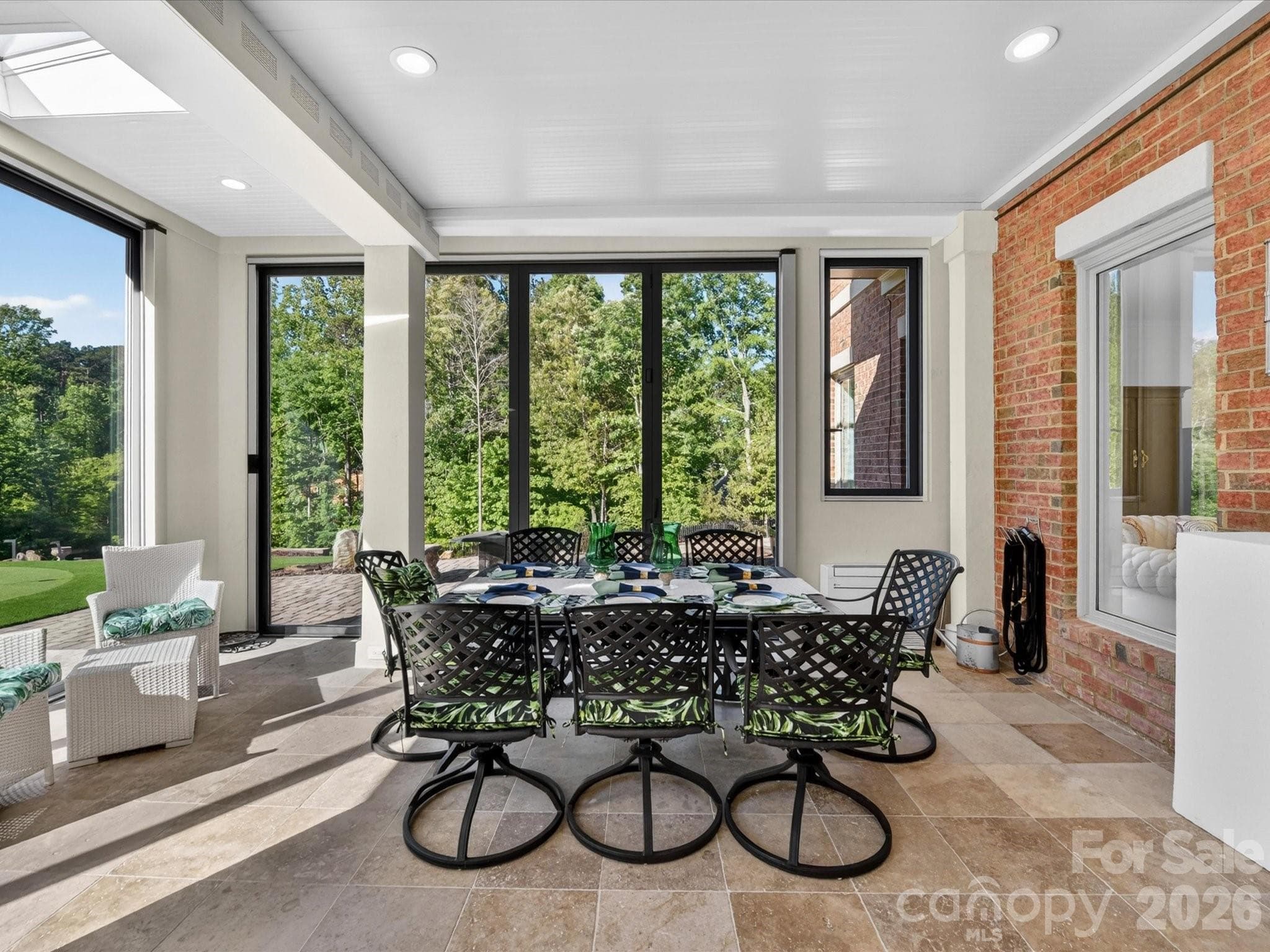 This 35' by 19' family room has space for both dining and lounging and provides incredible views. - 2723 Providence Pine Lane, Charlotte