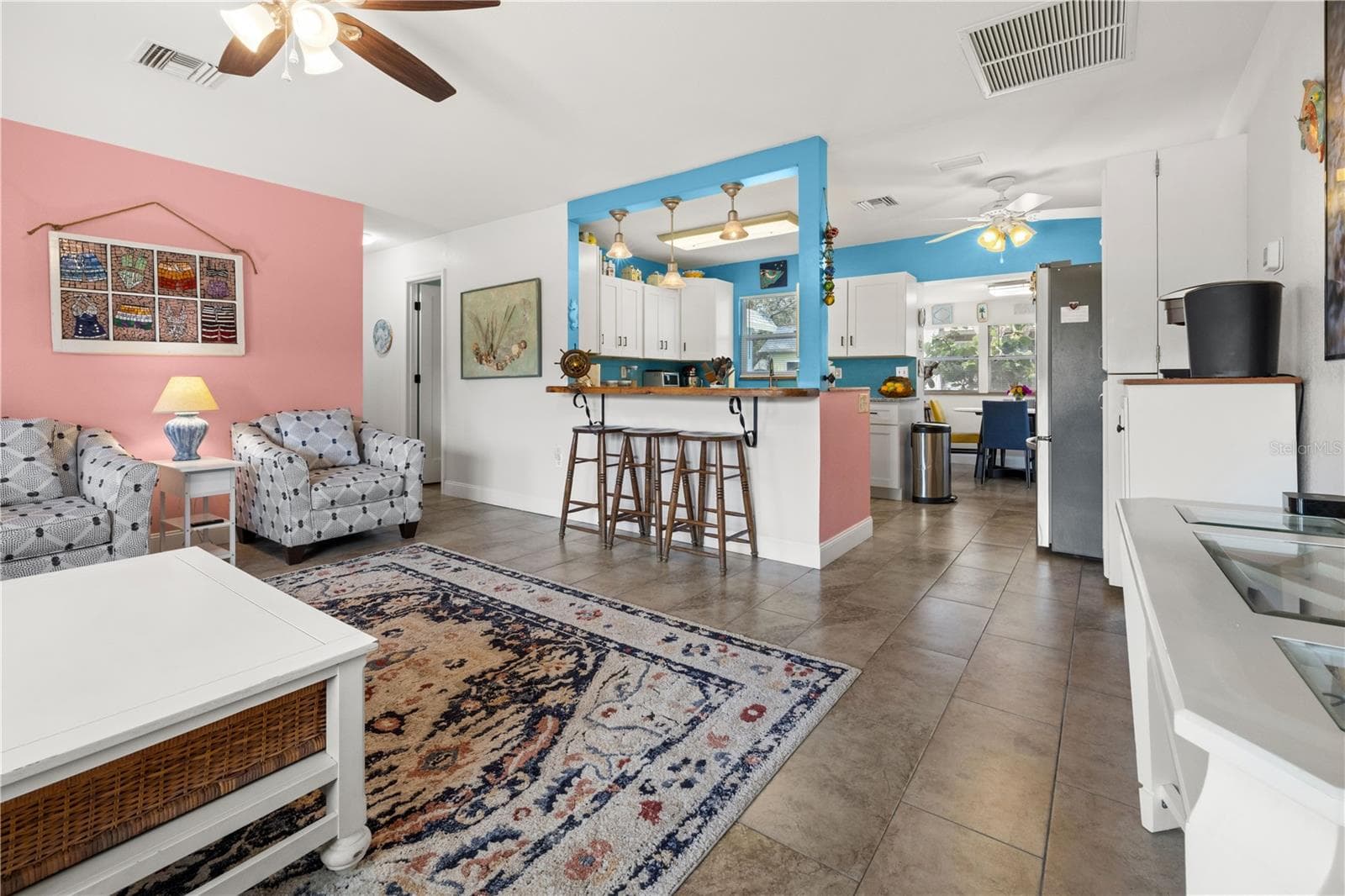 It has an open floor plan in the living area with a counter that peeks into the kitchen.  The dining area in the rear has views of the yard. - 7035 DUKE ST, ENGLEWOOD