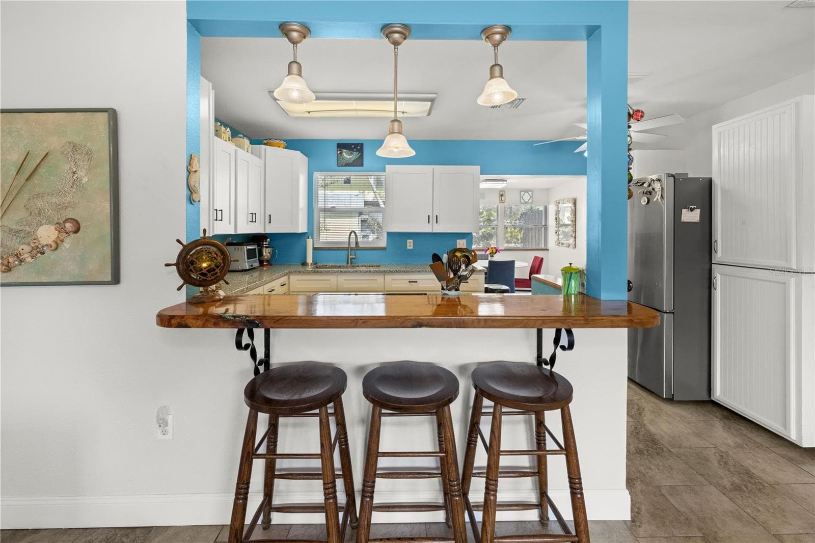 The pass through counter connects the living room to the kitchen and the dining area.  It's a great open concept that allows conversations while you cook! - 7035 DUKE ST, ENGLEWOOD