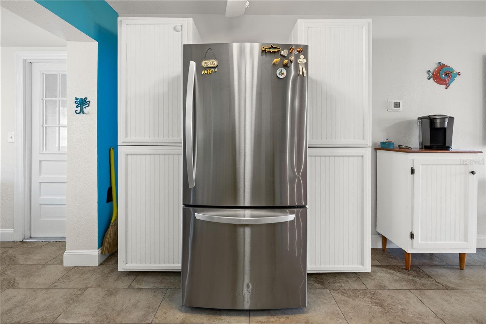 In addition to the cabinets in the kitchen, there is generous cabinet storage on the refrigerator side. - 7035 DUKE ST, ENGLEWOOD
