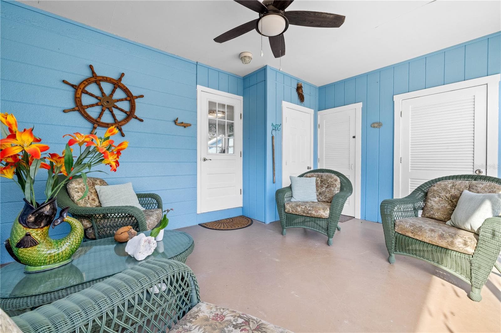 Here is another view of the lanai.  The glass door leads into the house.  The other three doors open to extra closet space, and outdoor shower and the laundry. - 7035 DUKE ST, ENGLEWOOD