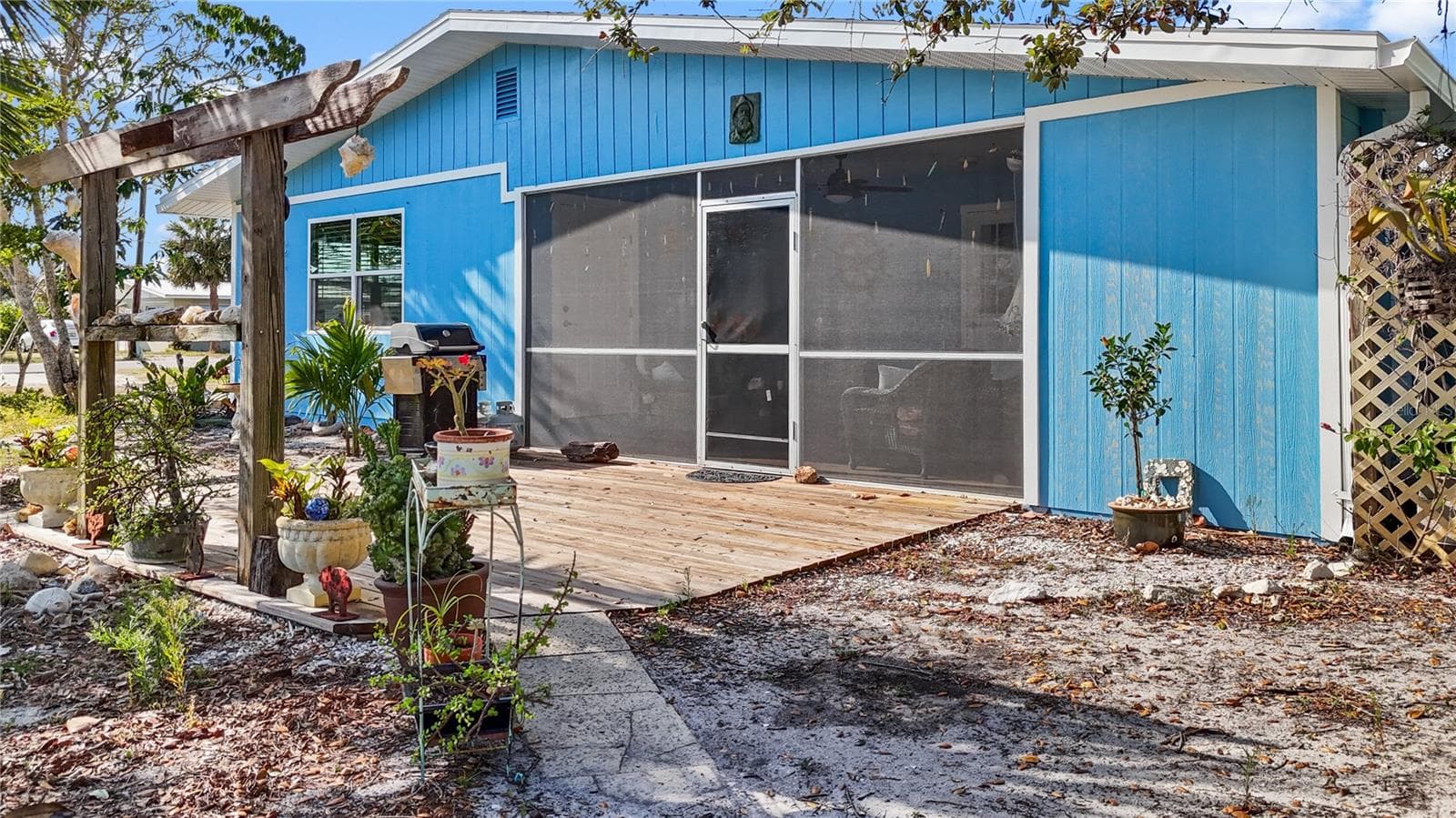 Outside of the screened lanai is a wooden deck area, which is a great place to sit on spring evenings! - 7035 DUKE ST, ENGLEWOOD
