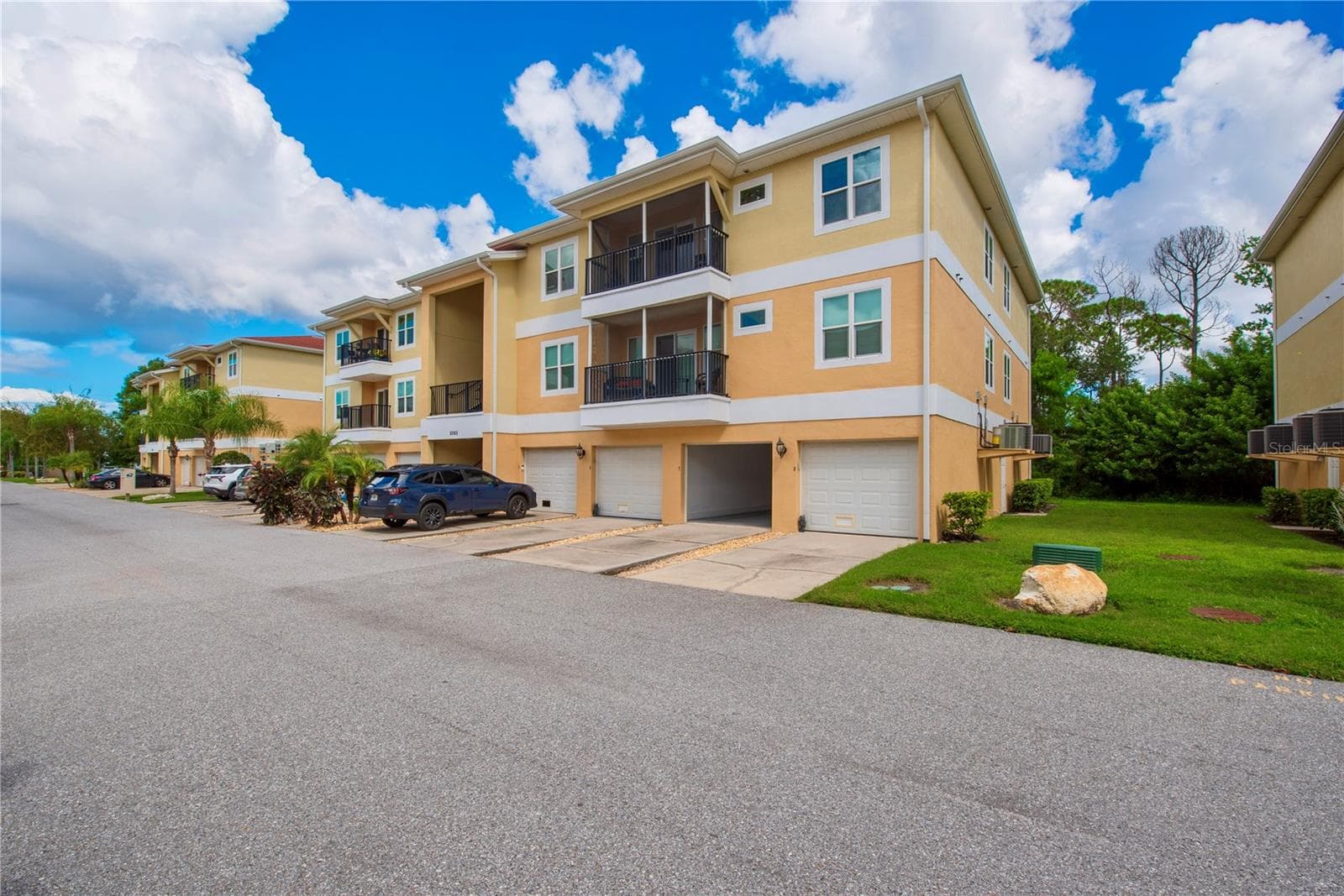Garage #7, on right side of building with the open door, plus storage room right across the hall from the garage. - 5065 ROYAL PALMS WAY #303, NEW PORT RICHEY