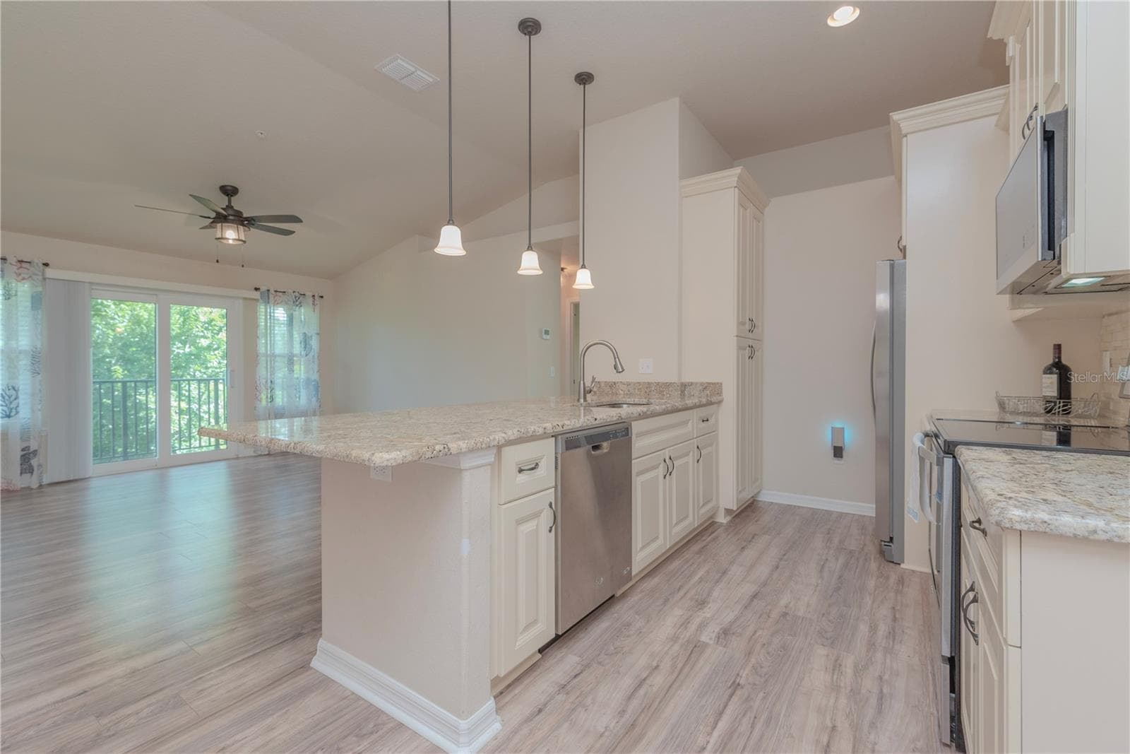 Kitchen with stainless steel appliances and closet pantry. - 5065 ROYAL PALMS WAY #303, NEW PORT RICHEY